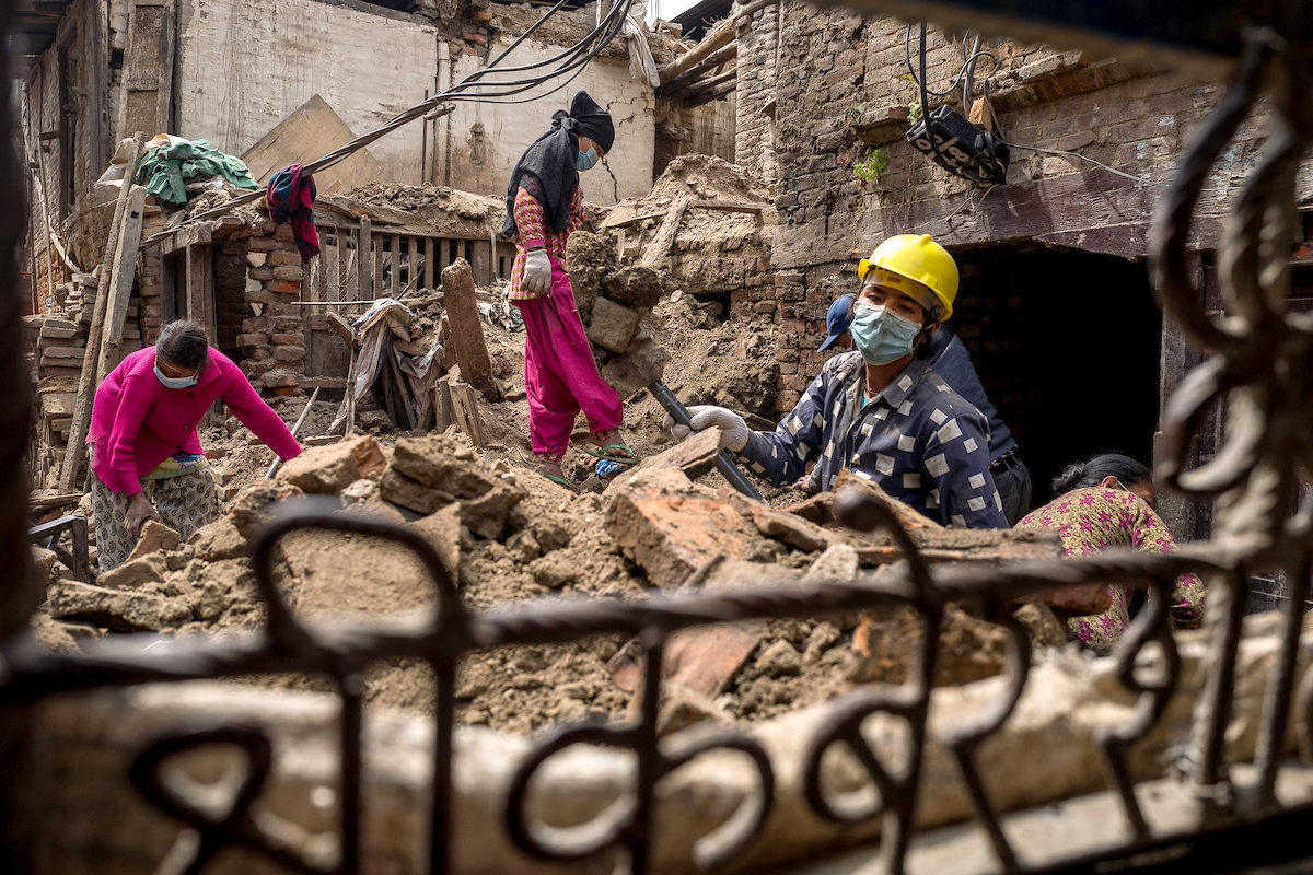 Labourers clear debris from a collapsed home in Bhaktapur, Nepal. Labourers clear debris from a collapsed home in Bhaktapur, Nepal.