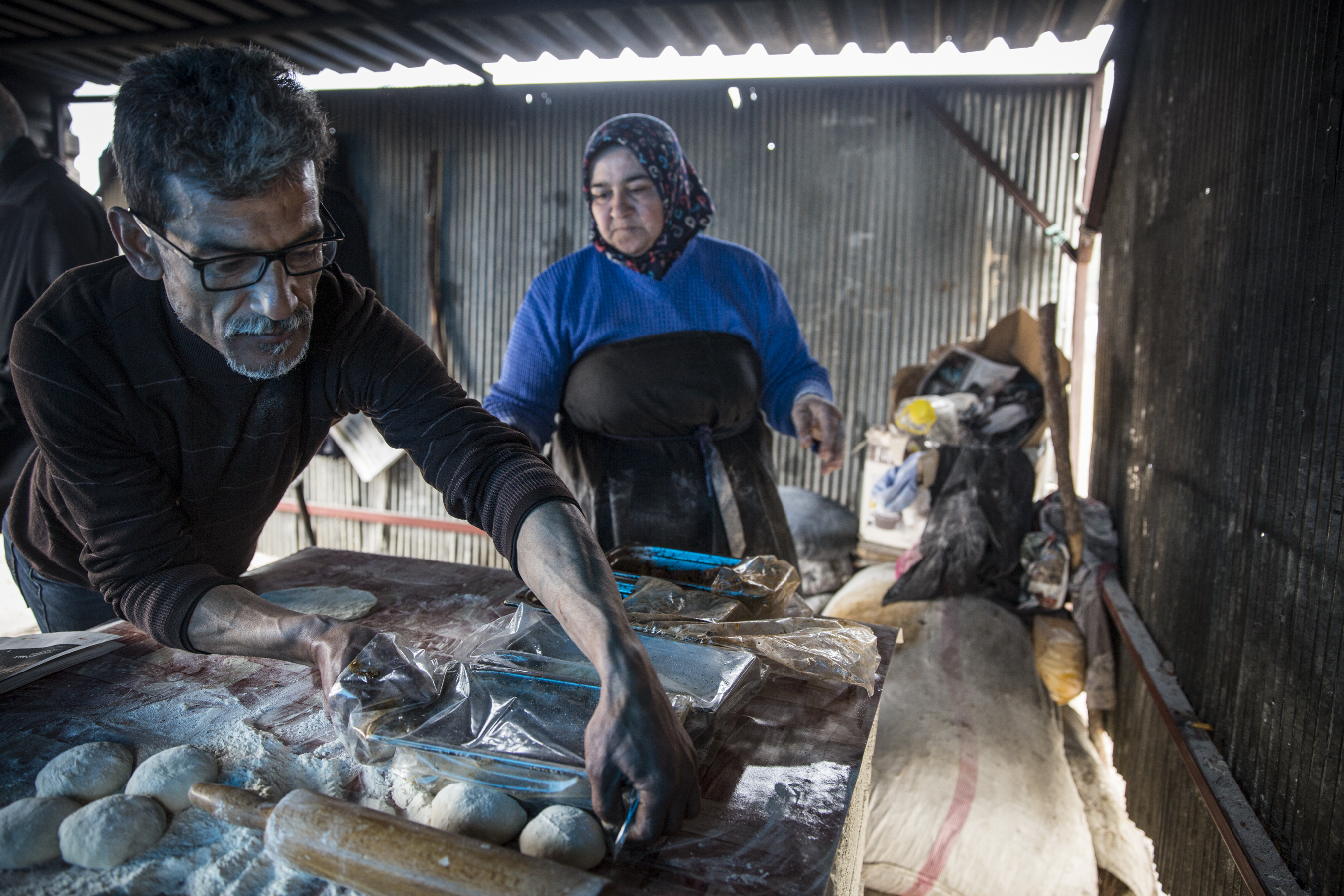 A man and woman making flatbread