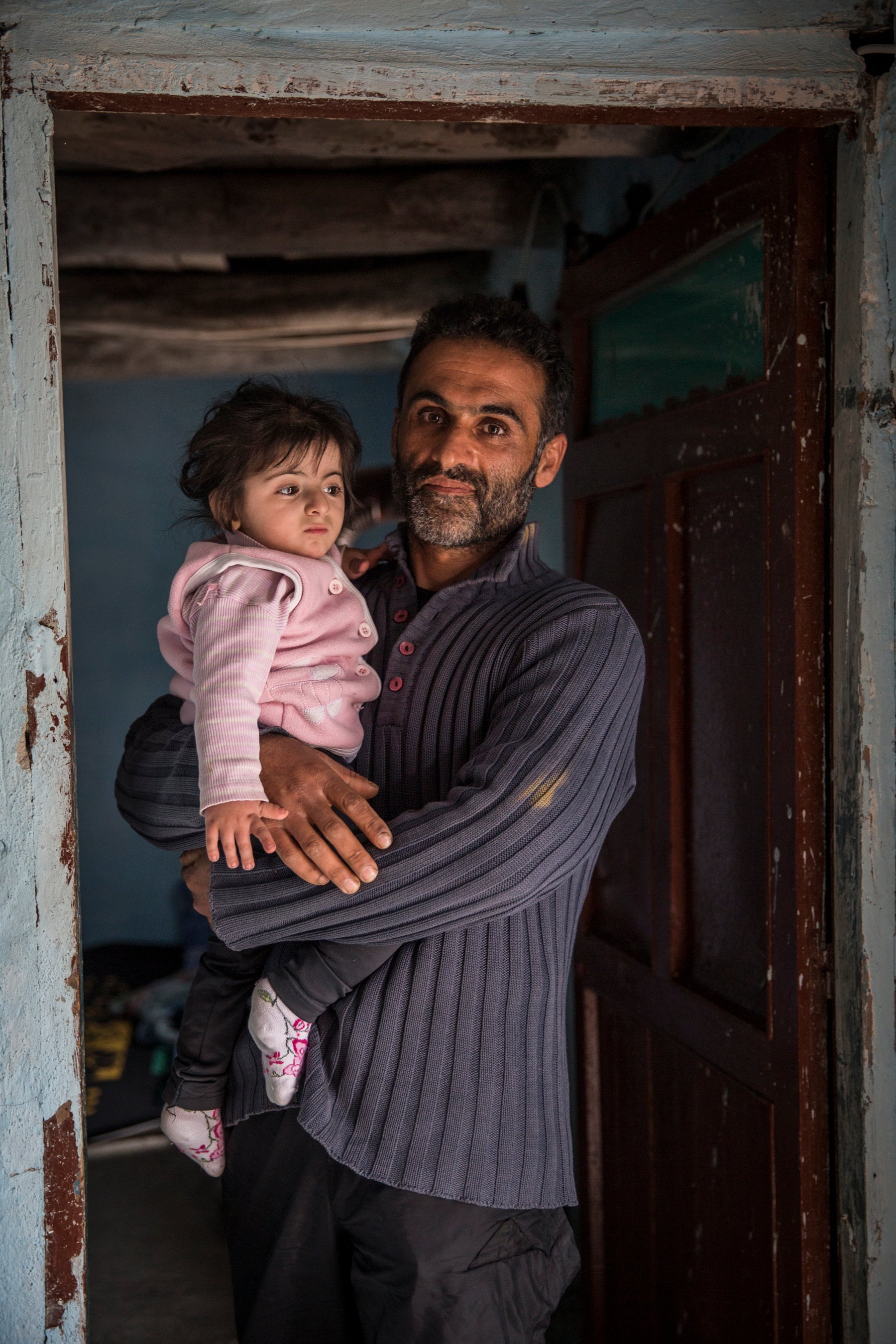 A man holds his young daughter