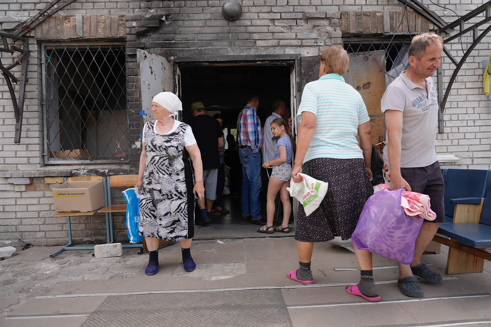 Residents in Moschun village get food assistance in the town center.