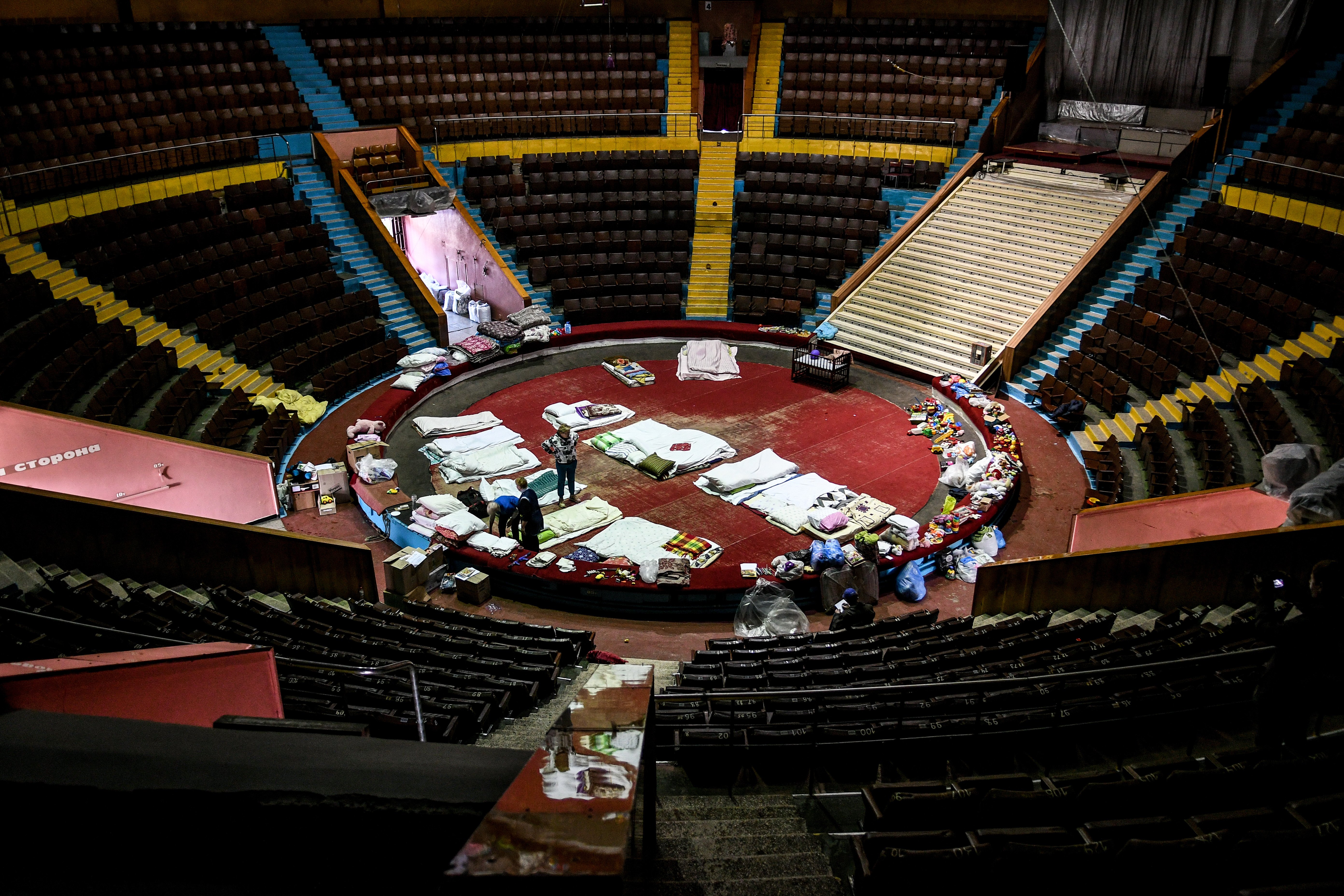 Mattresses and blankets fill the arena of the state circus in Ukraine's southeastern town of Zaporizhzhia, which has been converted into a logistics hub for those displaced by the conflict.