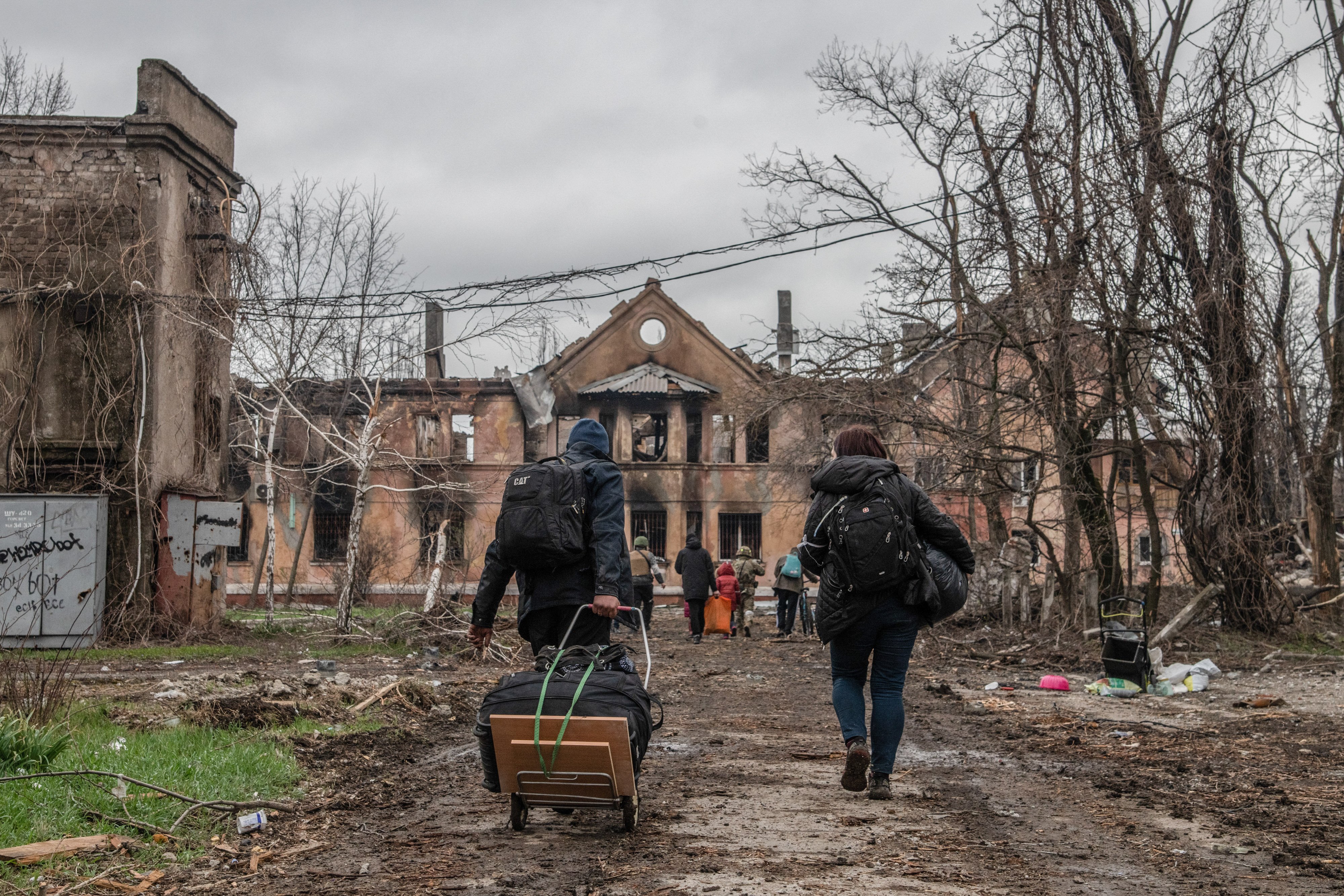 Residents evacuate from an eastern neighbourhood of Mariupol on 18 April 2022. Efforts to open safe passage out of the devastated city have progressed slowly and often collapsed. Most recently, around 100 people were evacuated on 2 May.