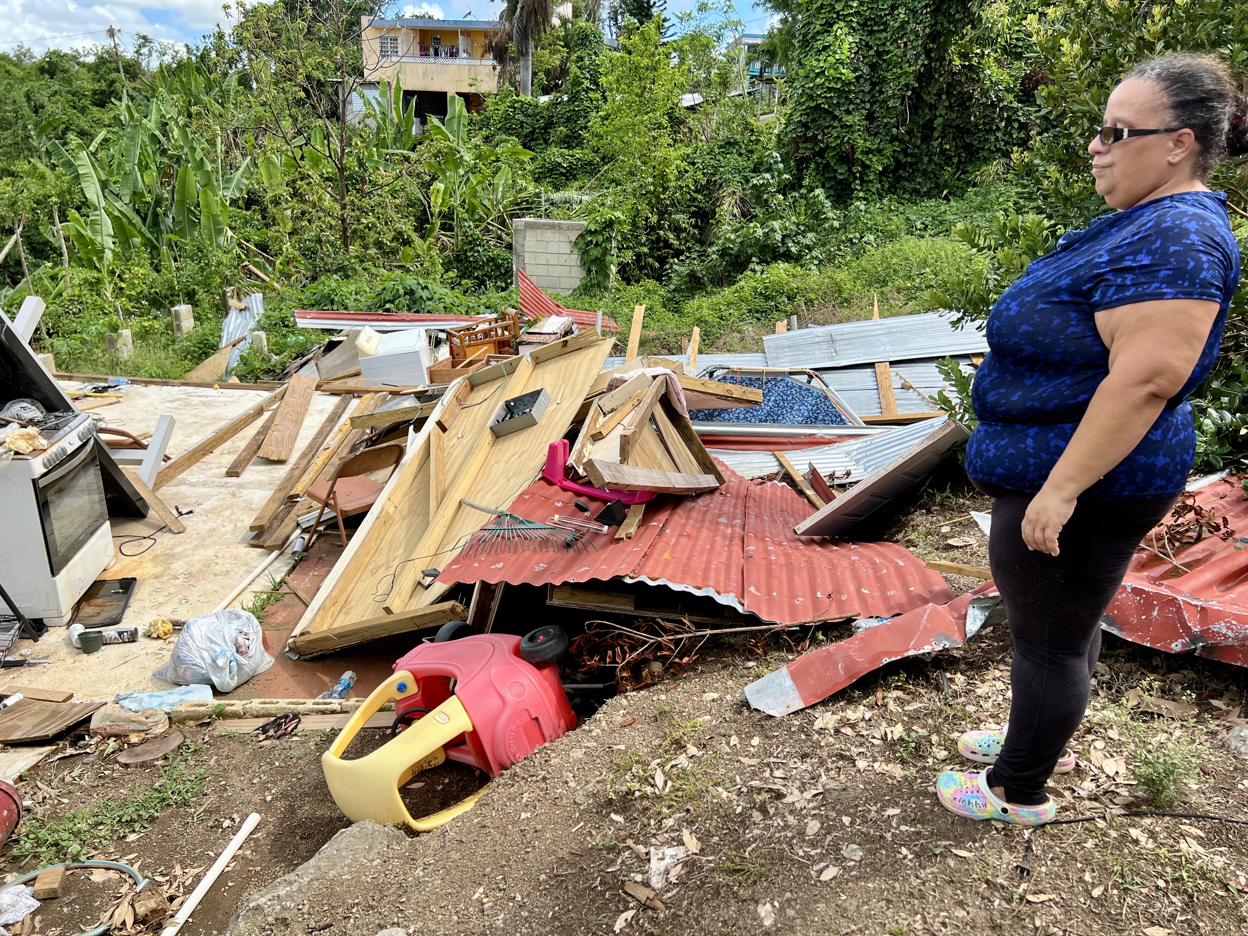 Jasmin Seda, next to the ruins of her home a month after Fiona hit, says government aid was painfully slow to arrive.