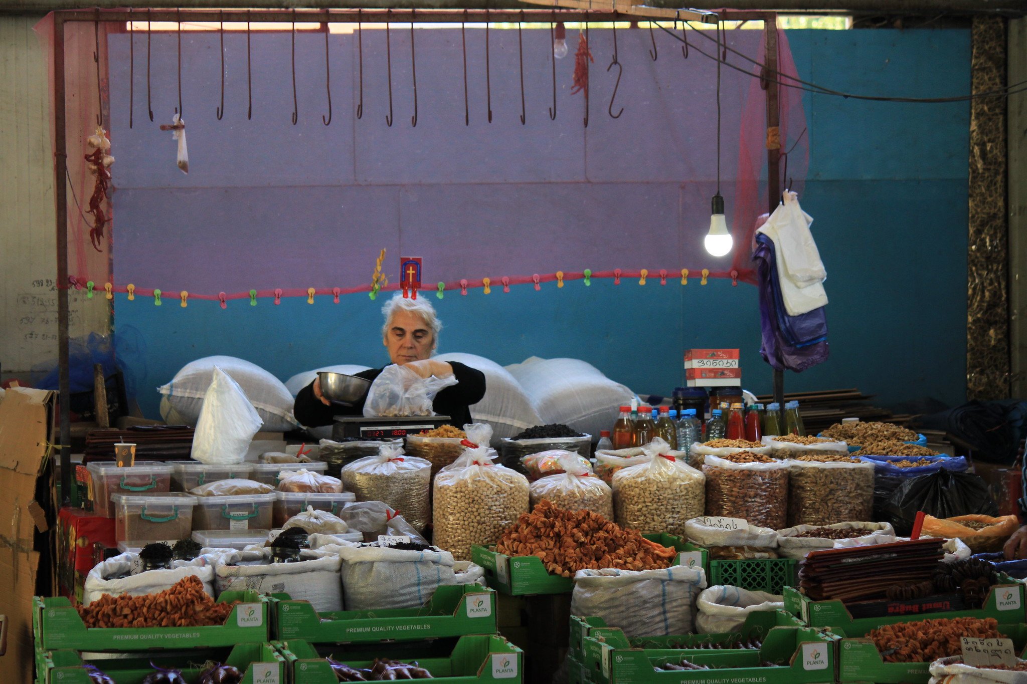 A dry fruits seller prepares her stall at the famers’ market in Tbilisi in September 2022. Costs of basic goods have skyrocketed this year, leaving them out of reach for some Georgians.