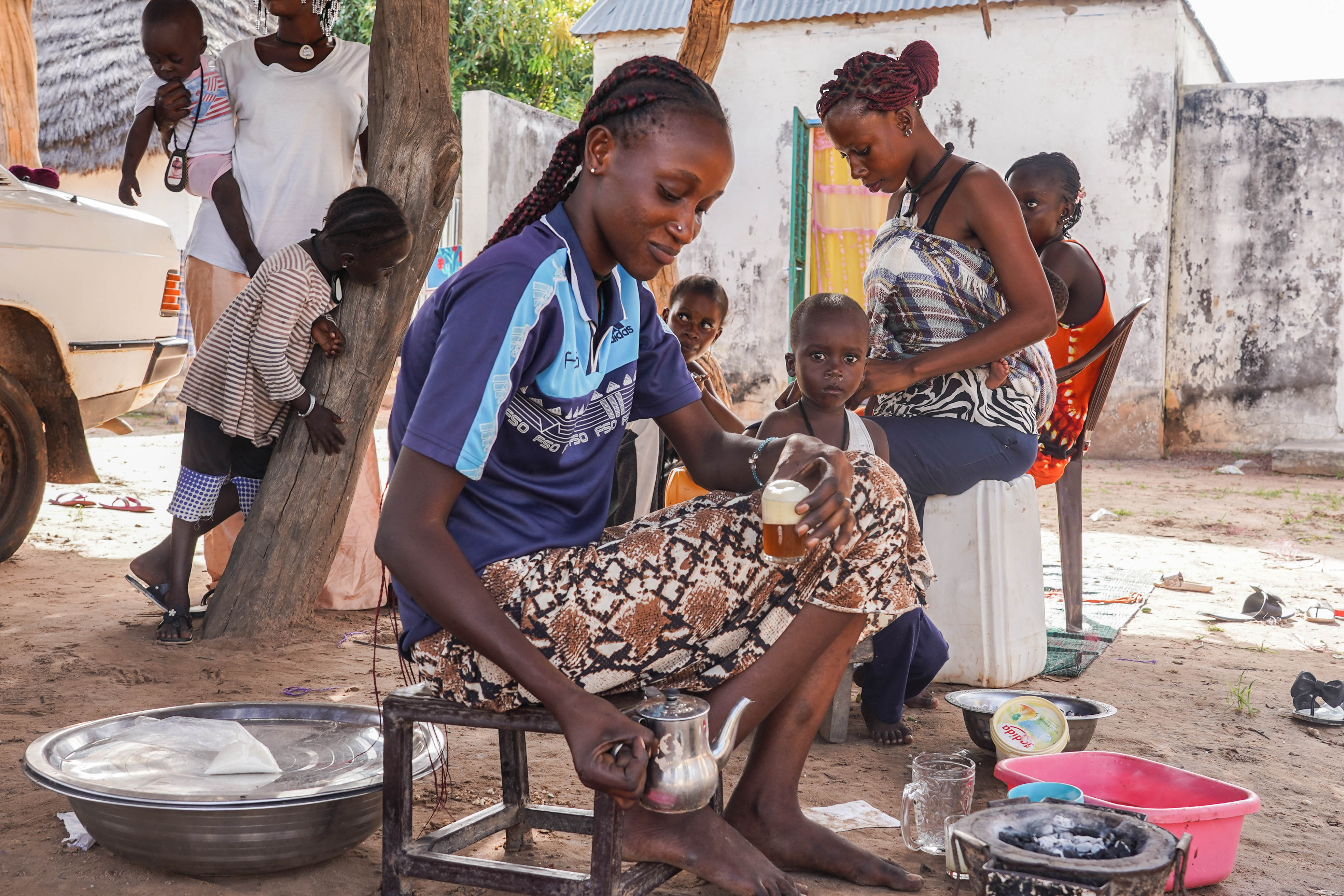 Members of the Ndigal sect prepare tea from a village in Senegal. The group was forcibly displaced from the Gambia in 2009. 