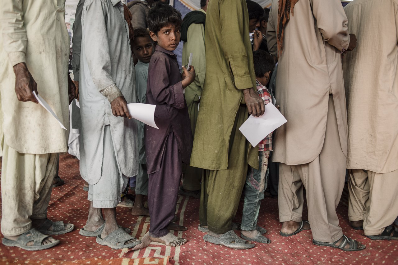 boy in Pakistan waiting for assistance 