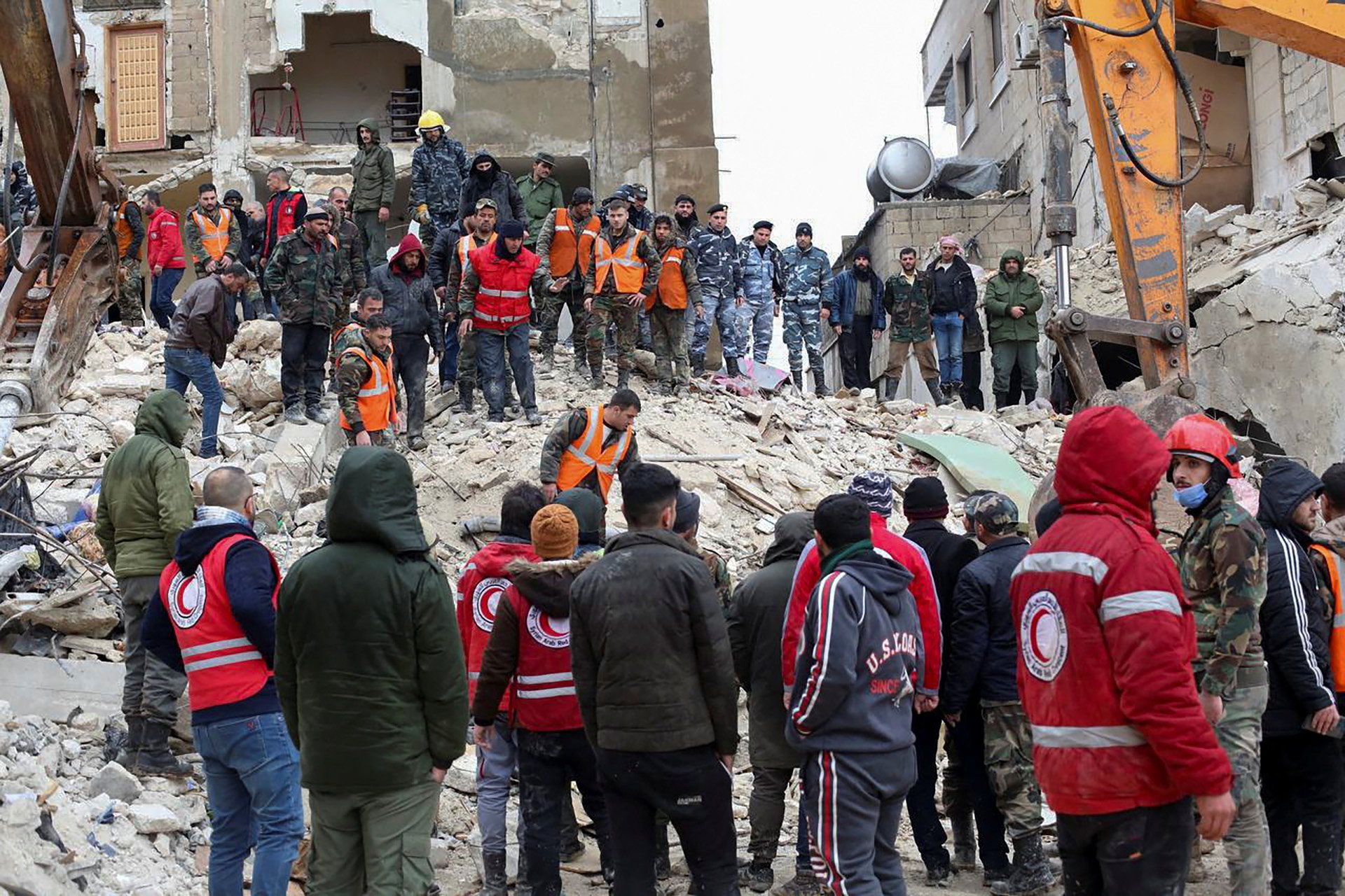 Rescuers search for survivors at the site of a collapsed building in Hama, Syria 6 February 2023.