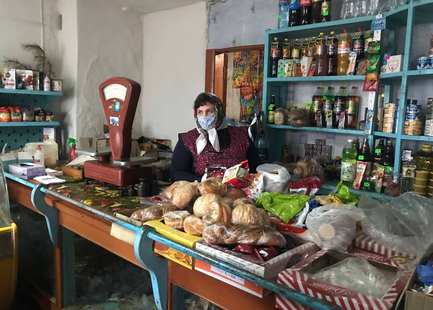 A woman tending a small shop close to the front lines in the Donbas region of Ukraine prior to Russia's full-scale invasion in February 2022. 