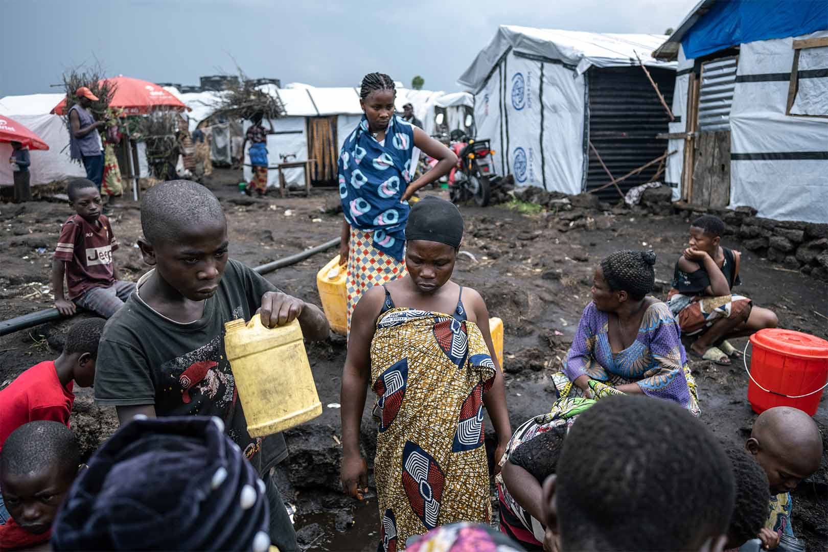 25-year-old Alice Maombi and other residents of the camp fill up water at Bulengo displacement camp near the eastern Congolese city of Goma. She has three children but is struggling to make ends meet since arriving in the camp earlier this year.