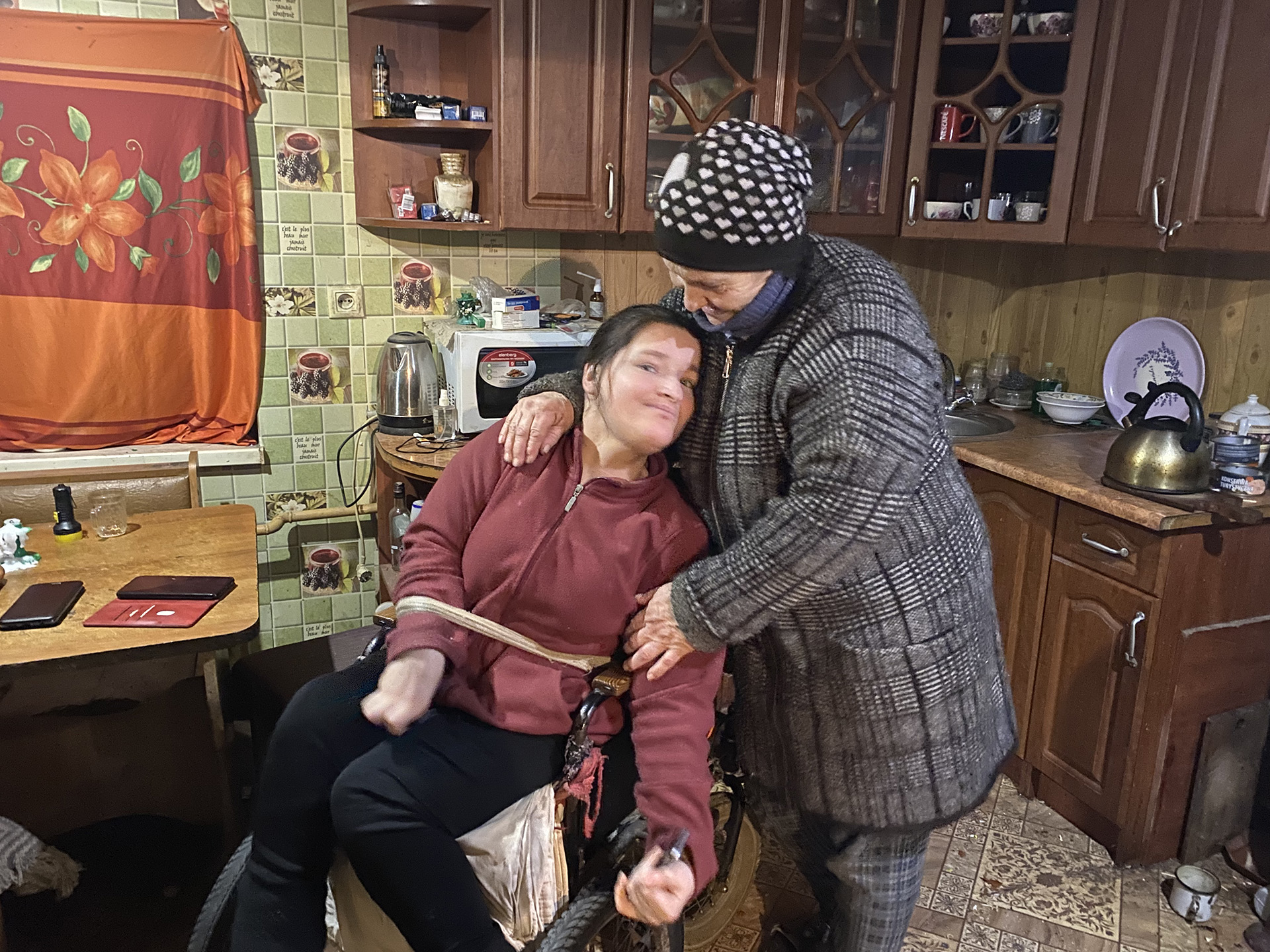 Iuliia (left), a 33-year-old woman with cerebral palsy, was injured in a missile strike on the village of Novosofiivka in December 2022, and her mother Katerina.