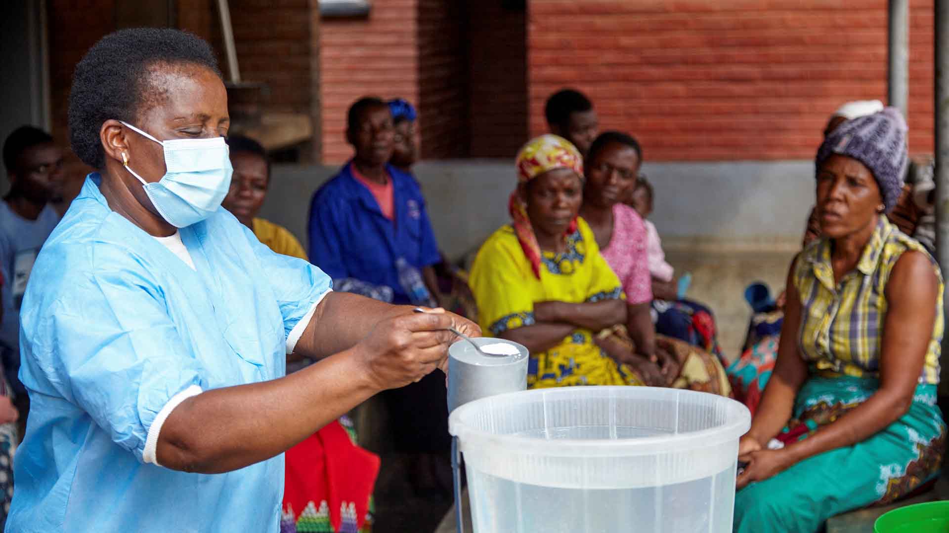 A health worker disinfects water at a clinic in southern Malawi, in November 2022.