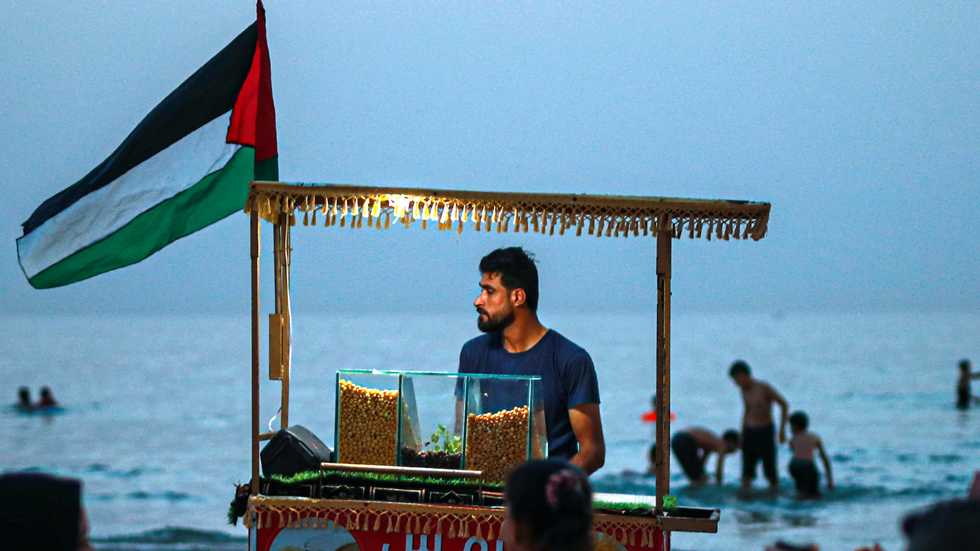 Photo of a man selling snacks on a Gaza beach