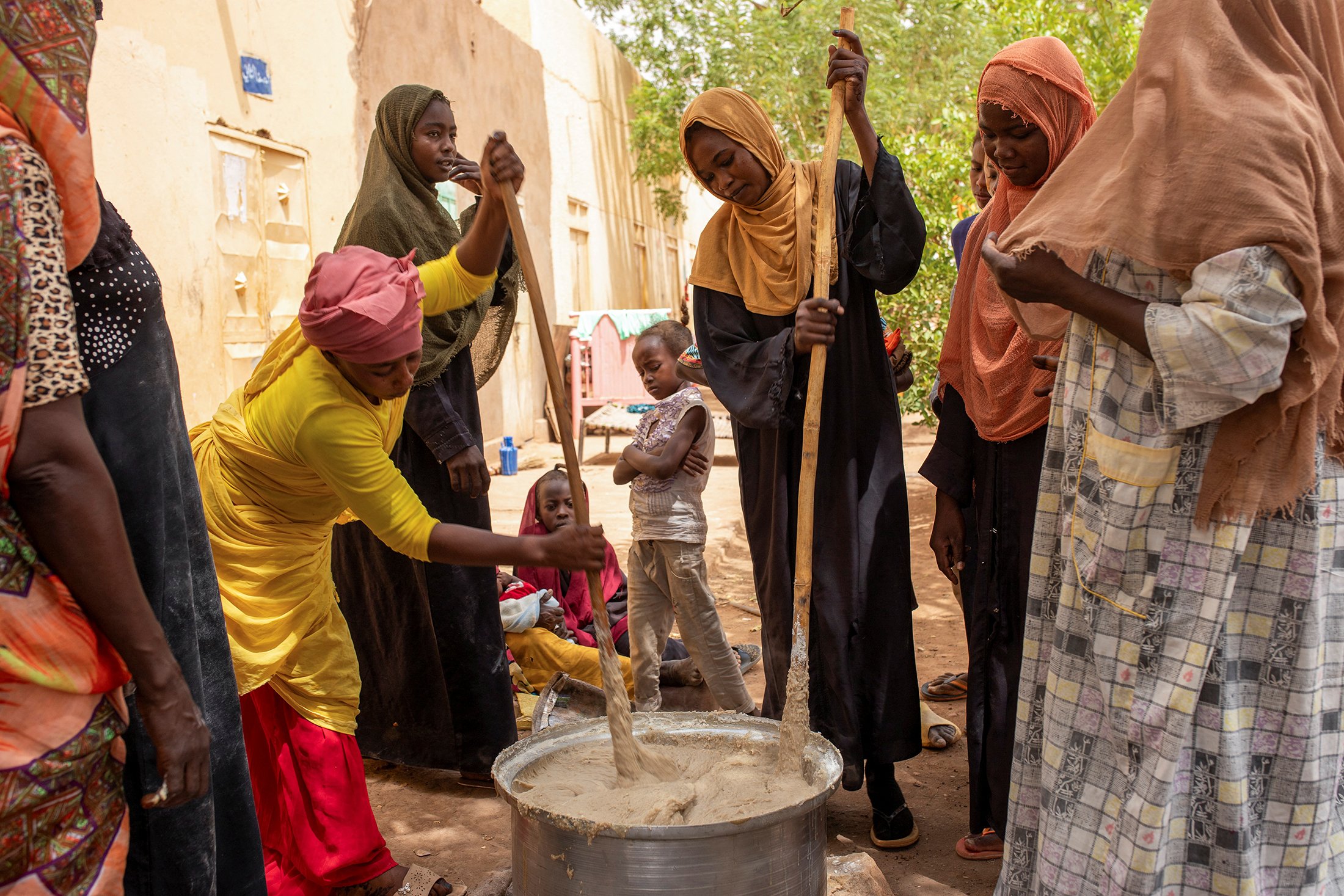 Volunteers from a community kitchen prepare meals for people affected by conflict and extreme hunger, in Omdurman, on 22 June, 2024.