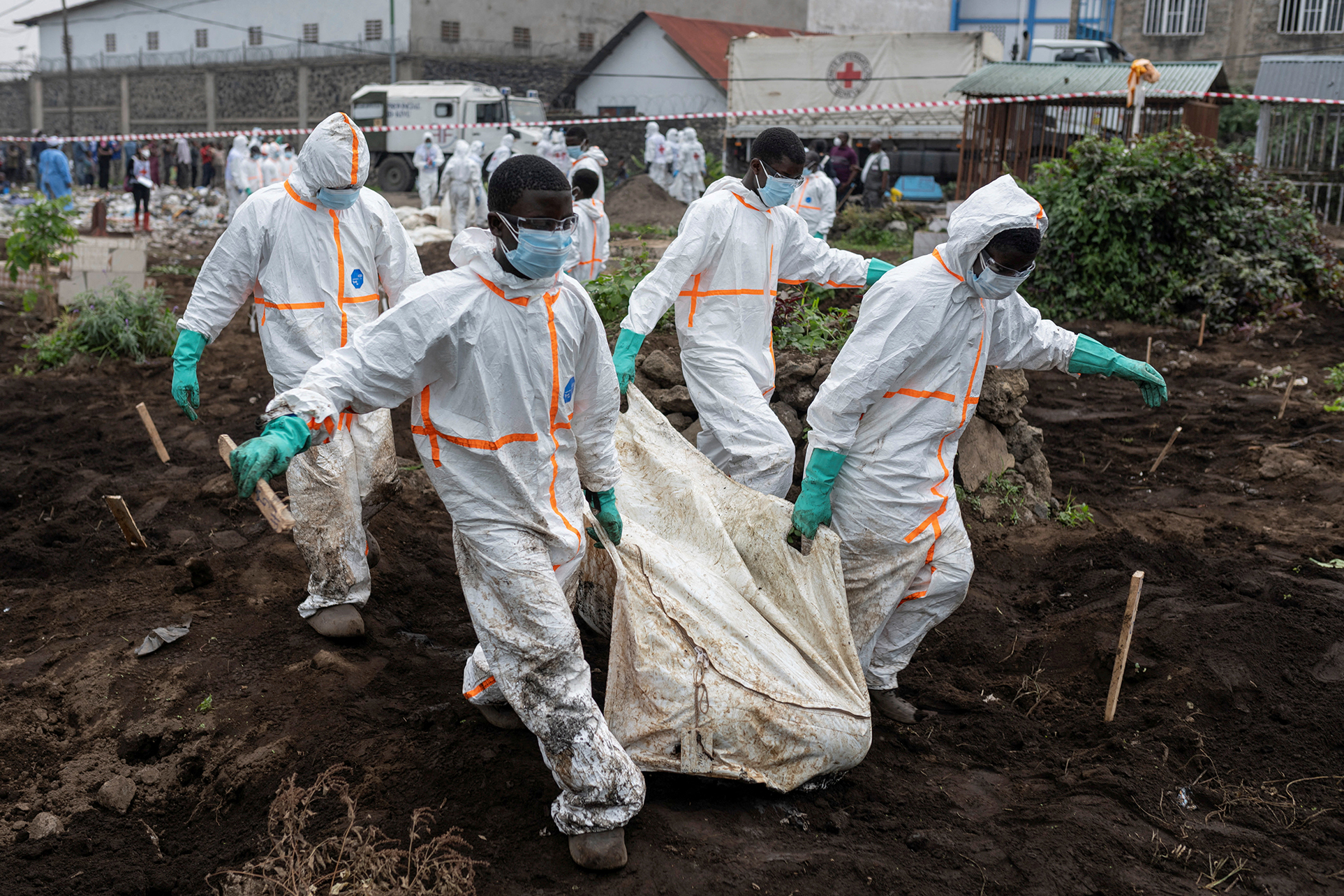 Red Cross staff are pictured wearing hazmat suits as they cary and bury victims after thousands of people were killed when the Rwanda-supported M23 armed group seized Goma, the biggest city in eastern Democratic Republic of the Congo, on 27 January.