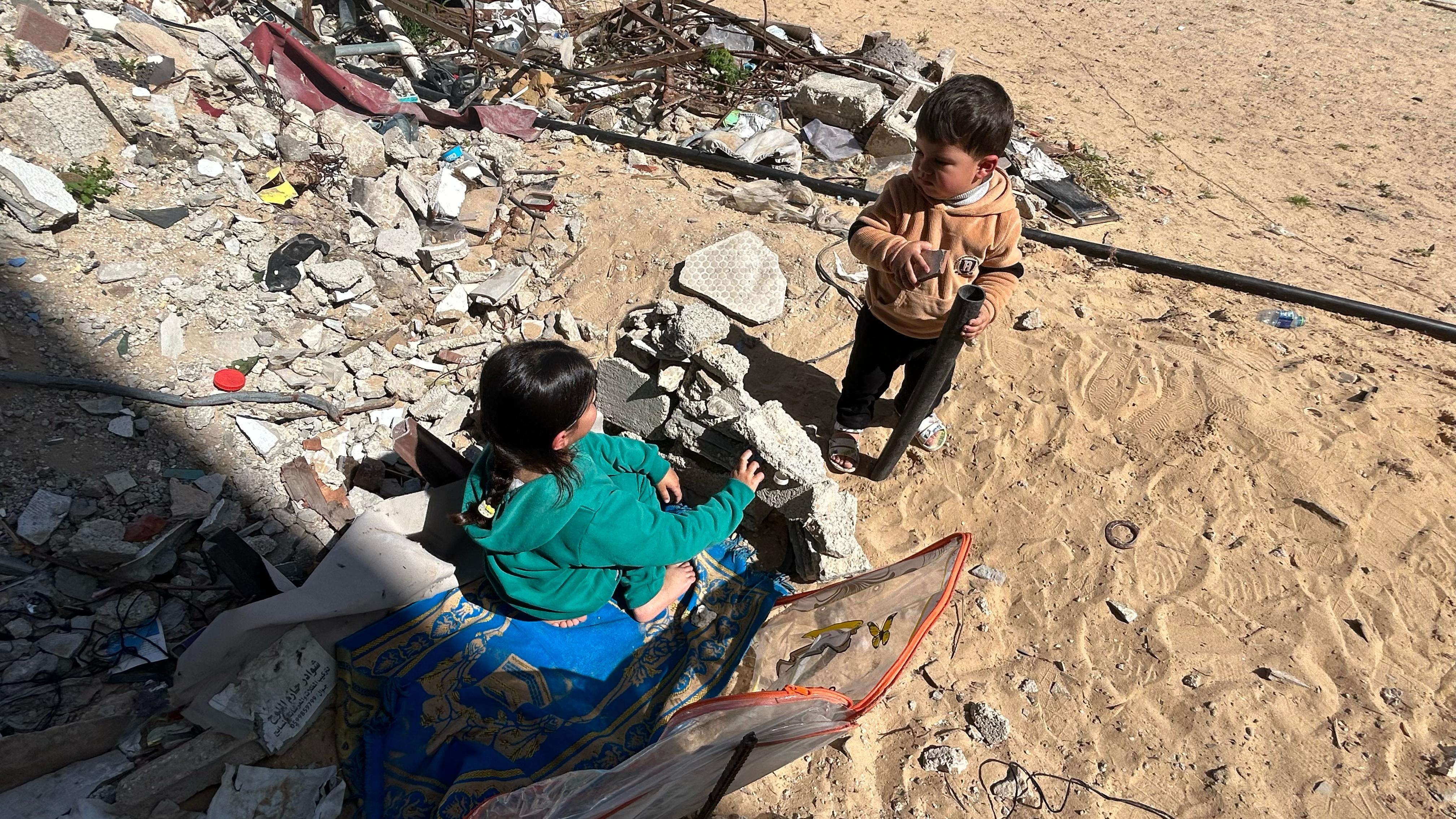 Two children play in the rubble in Gaza.