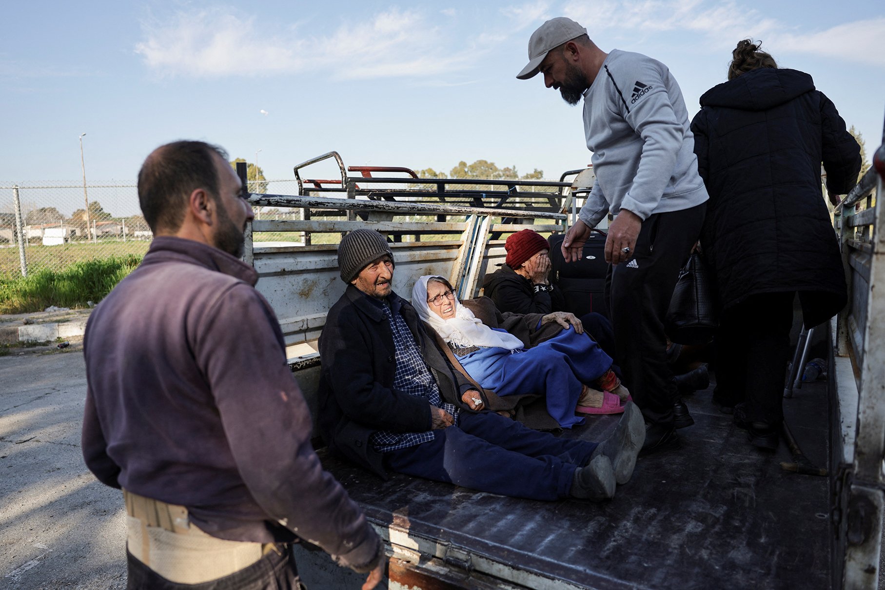 Syrian Alawite families return to their homes after seeking refuge at a Russian air base in Latakia during days of sectarian revenge killings, on 13 March 2025.