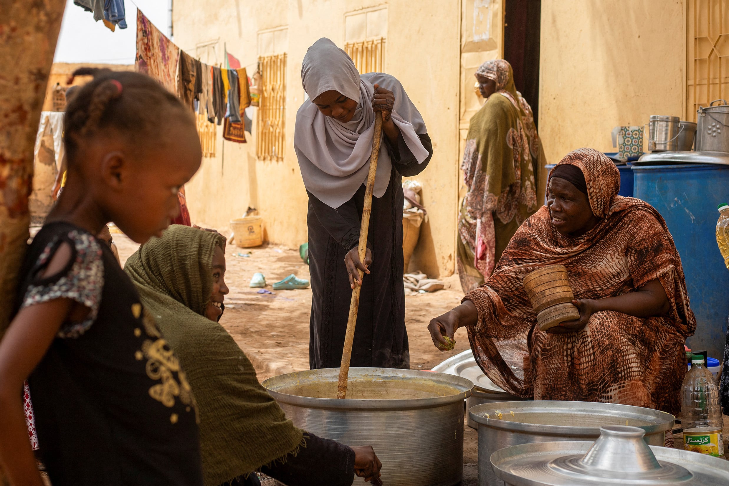 Sudanese volunteers prepare meals for people affected by conflict and extreme hunger in the city of Omdurman, on 20 June 2024. 