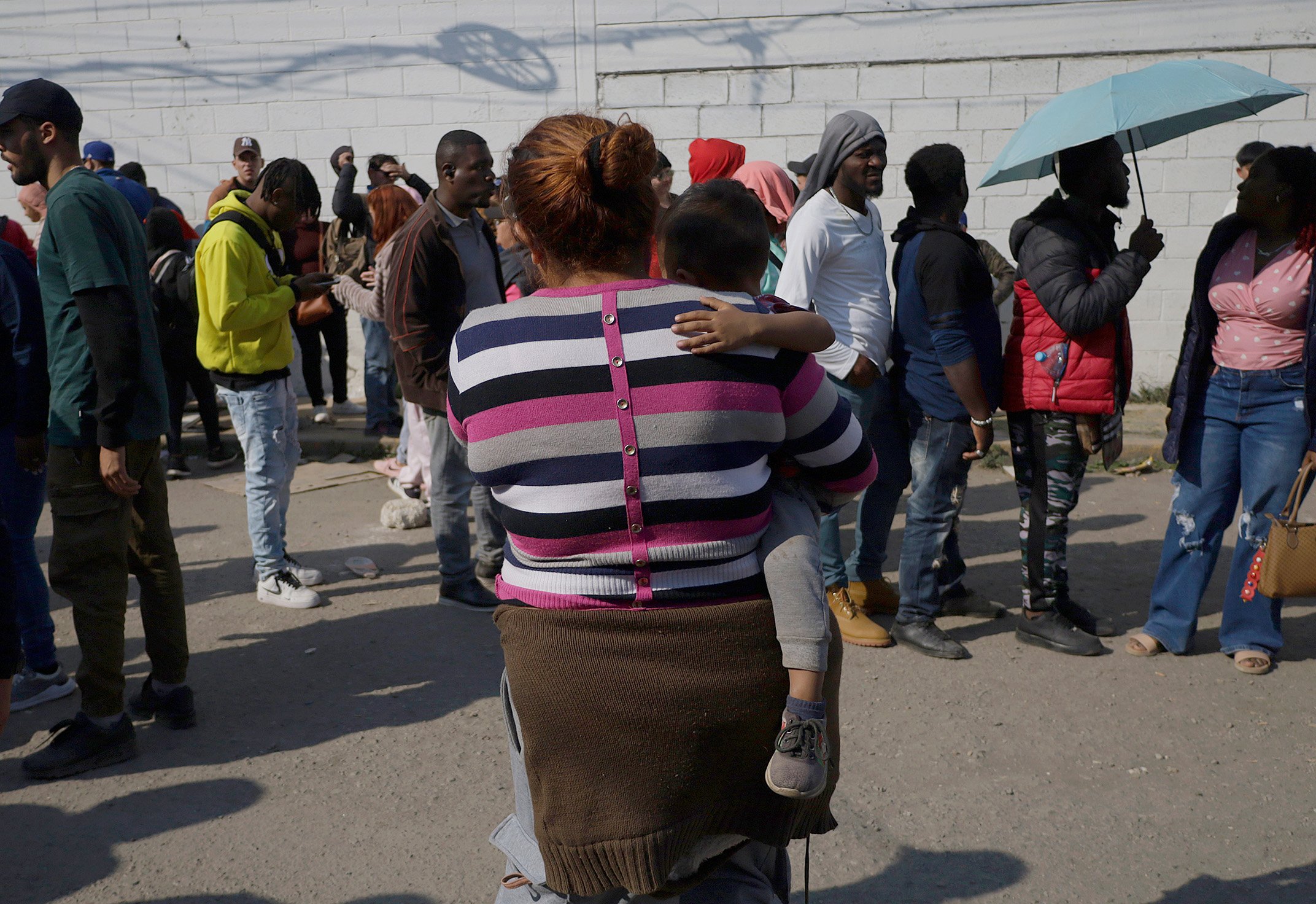 A migrant mother and baby wait outside the facilities of the Mexican Commission for Refugee Assistance in the State of Mexico, Mexico, on January 28, 2025, for an appointment.