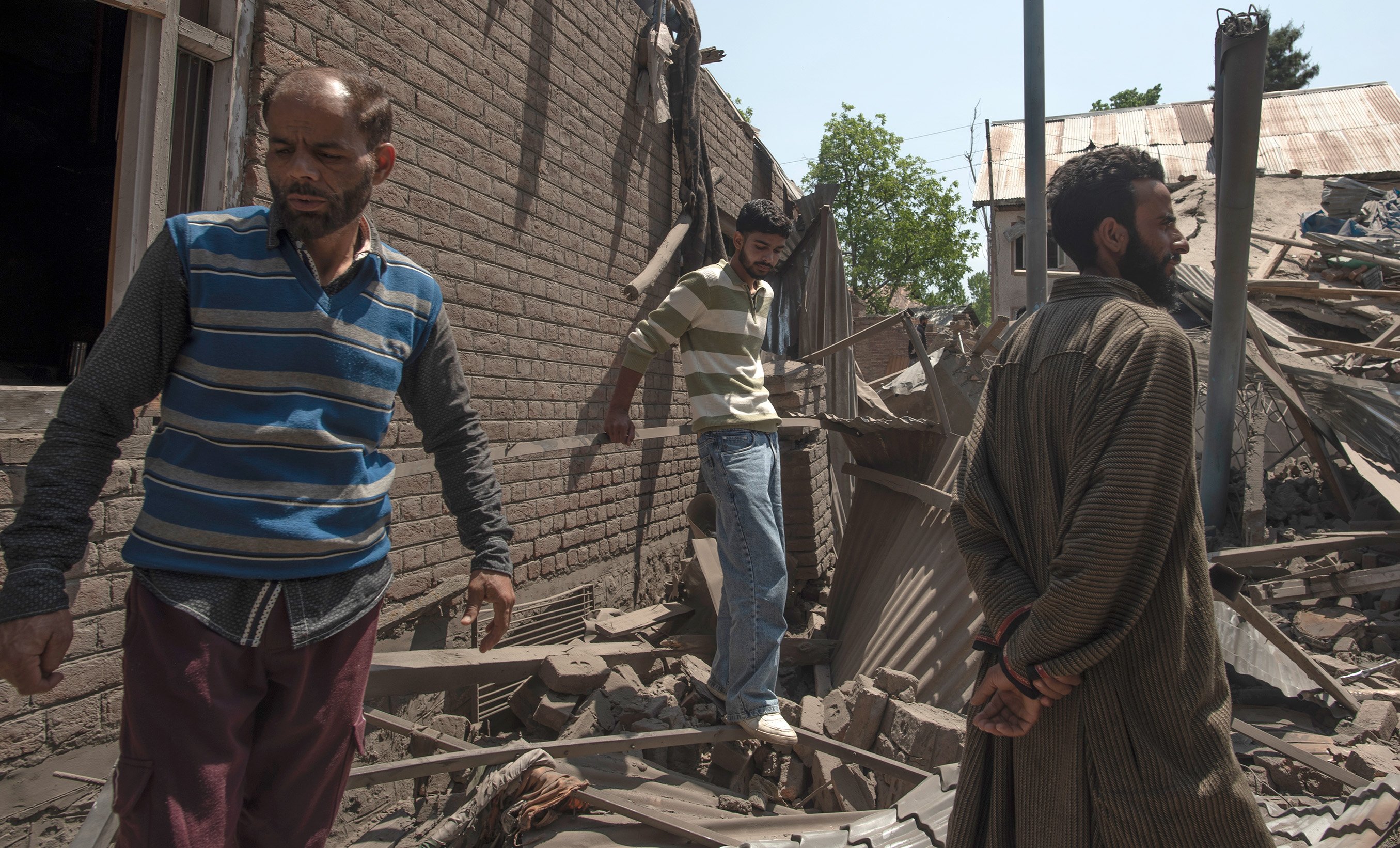Kashmiri villager inspect the debris of the blown-up family home of Ahsan Ul Haq Shiekh, a militant who officials say is involved in the deadly attack on tourists in Pahalgam, at Murran village in Pulwama, south of Srinagar, India.