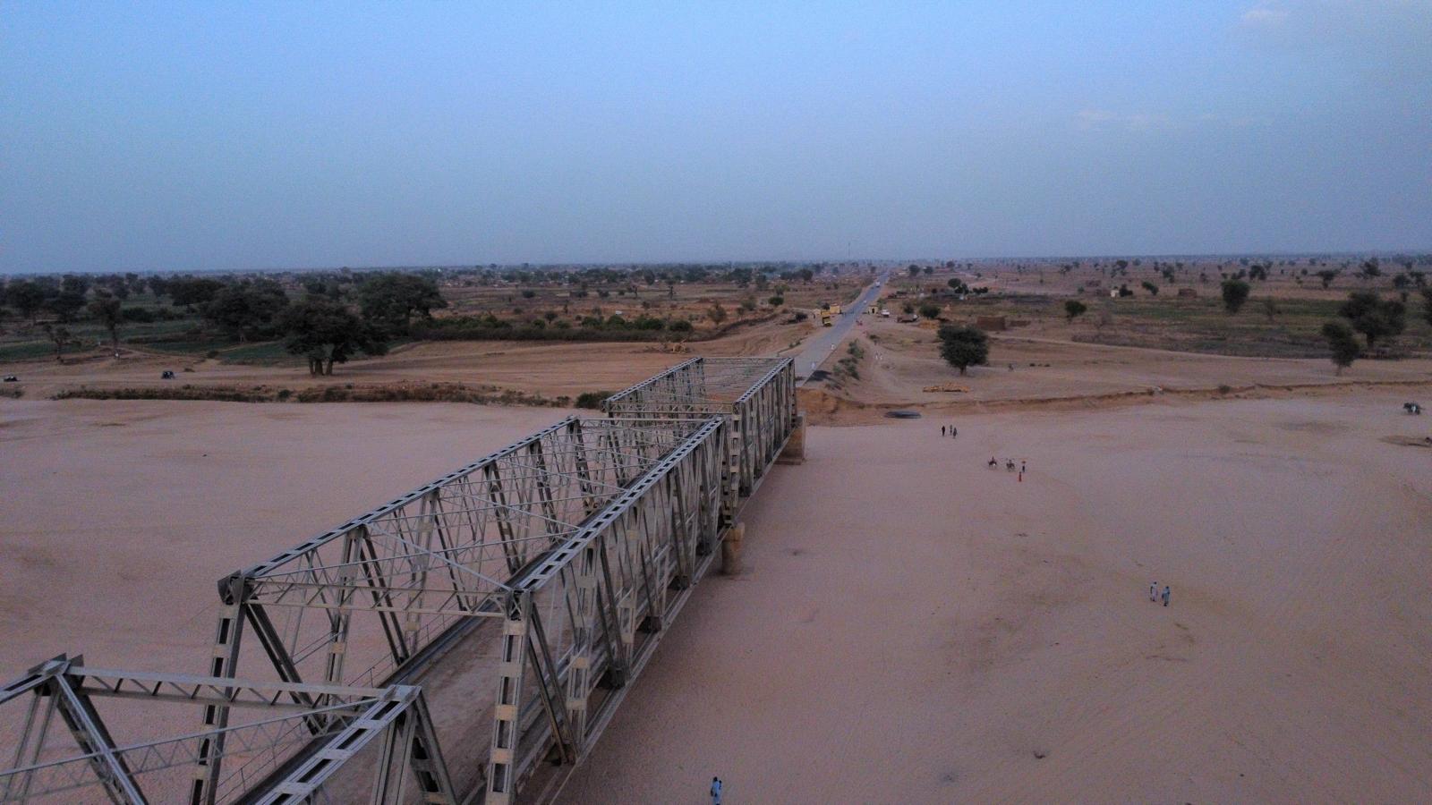 An aerial photograph of the broken bridge, which the UN has not received permission to mend from the SAF-aligned government, despite its critical role in enabling humanitarian access in Darfur.