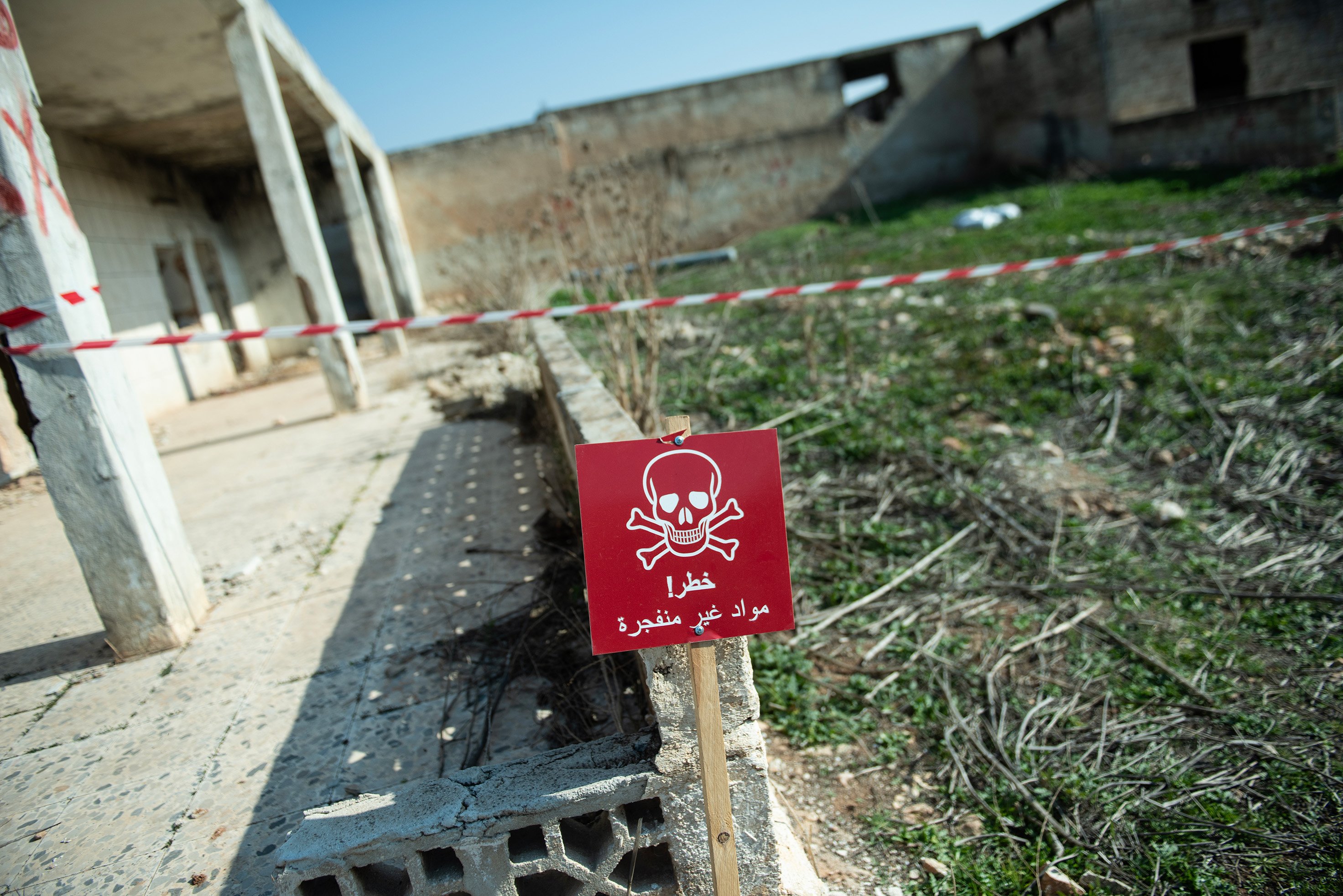 A sign in rural Idlib warns: “Danger! Unexploded ordnance.”