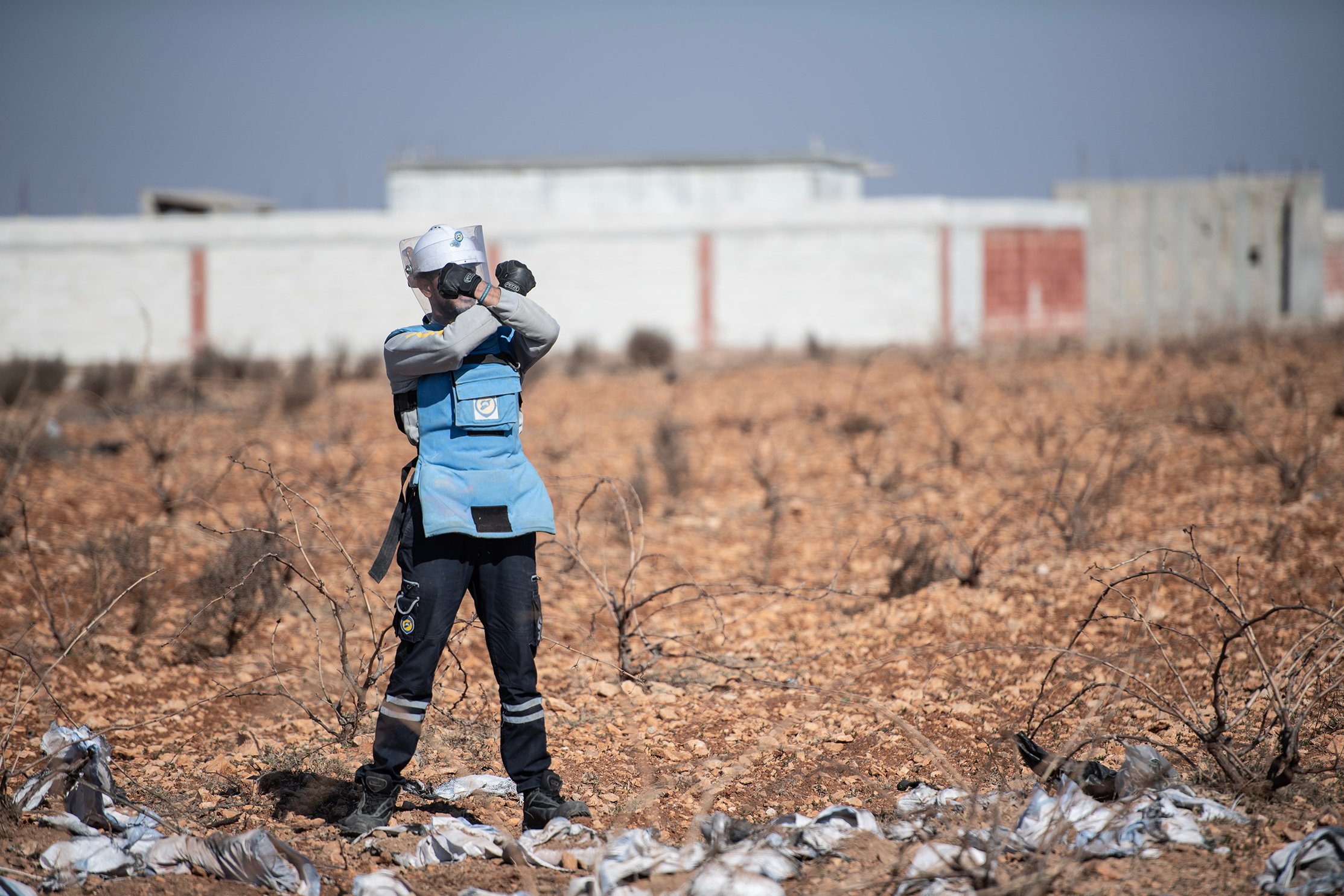 Ammar Zamzam, a deminer with the White Helmets, at work demining a field outside Homs.