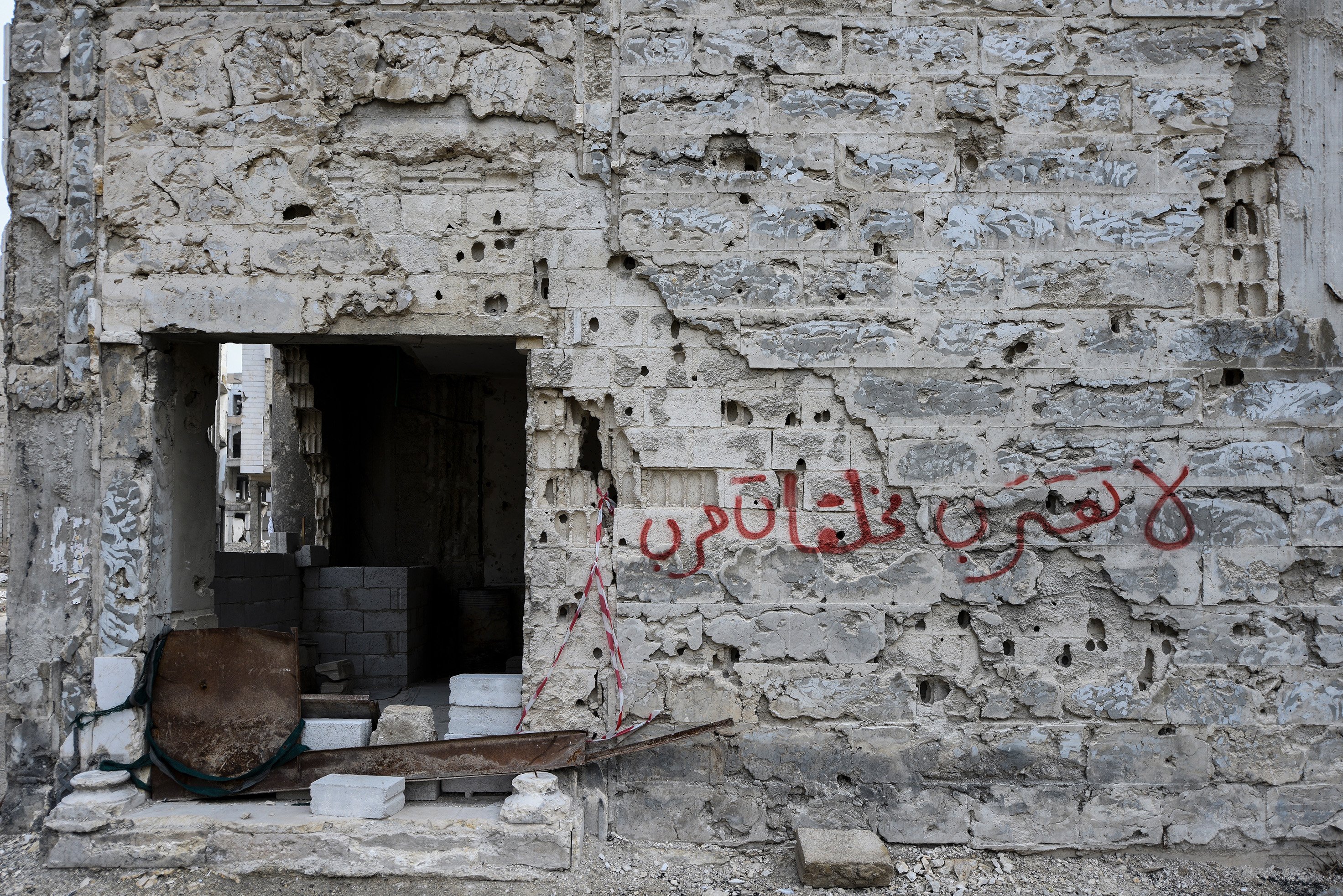 Graffiti in Jobar warns of the presence of unexploded remnants of war.  