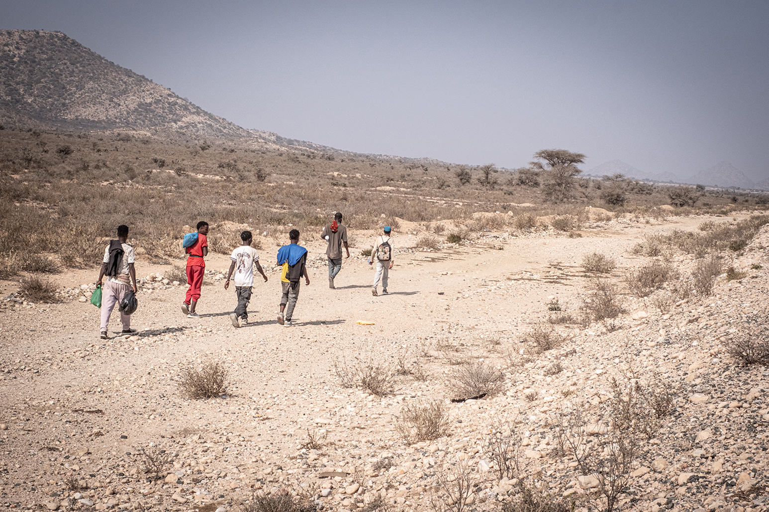 A group of Ethiopian migrants walking through Somaliland. They follow the main road, but divert when they see police patrols and checkpoints.