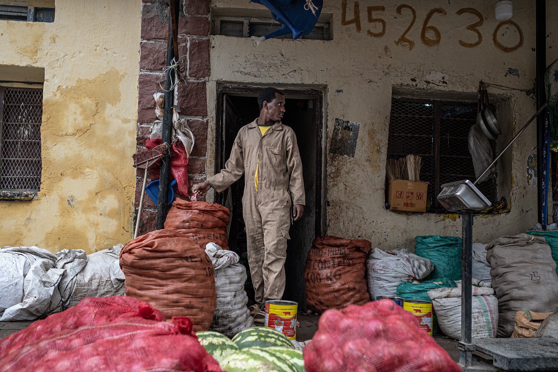 Adam Tsegay, a 26-year-old Ethiopian migrant, is pictured at work in a small grocery shop along Hargeisa’s Jijiga-Yar Road in Somaliland.