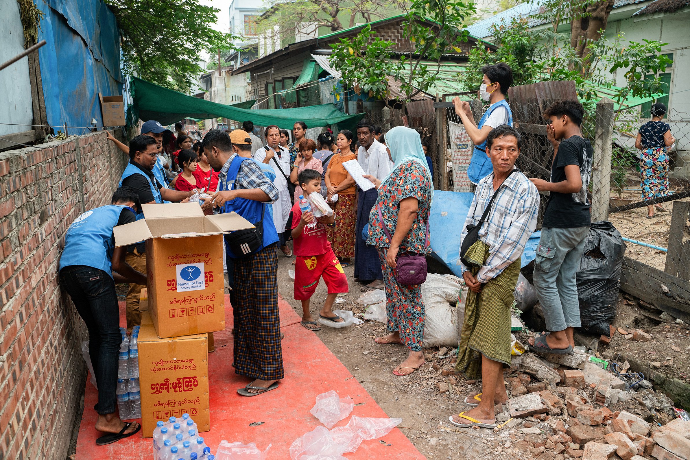 People stand by collecting aid in Mandalay, Myanmar.
