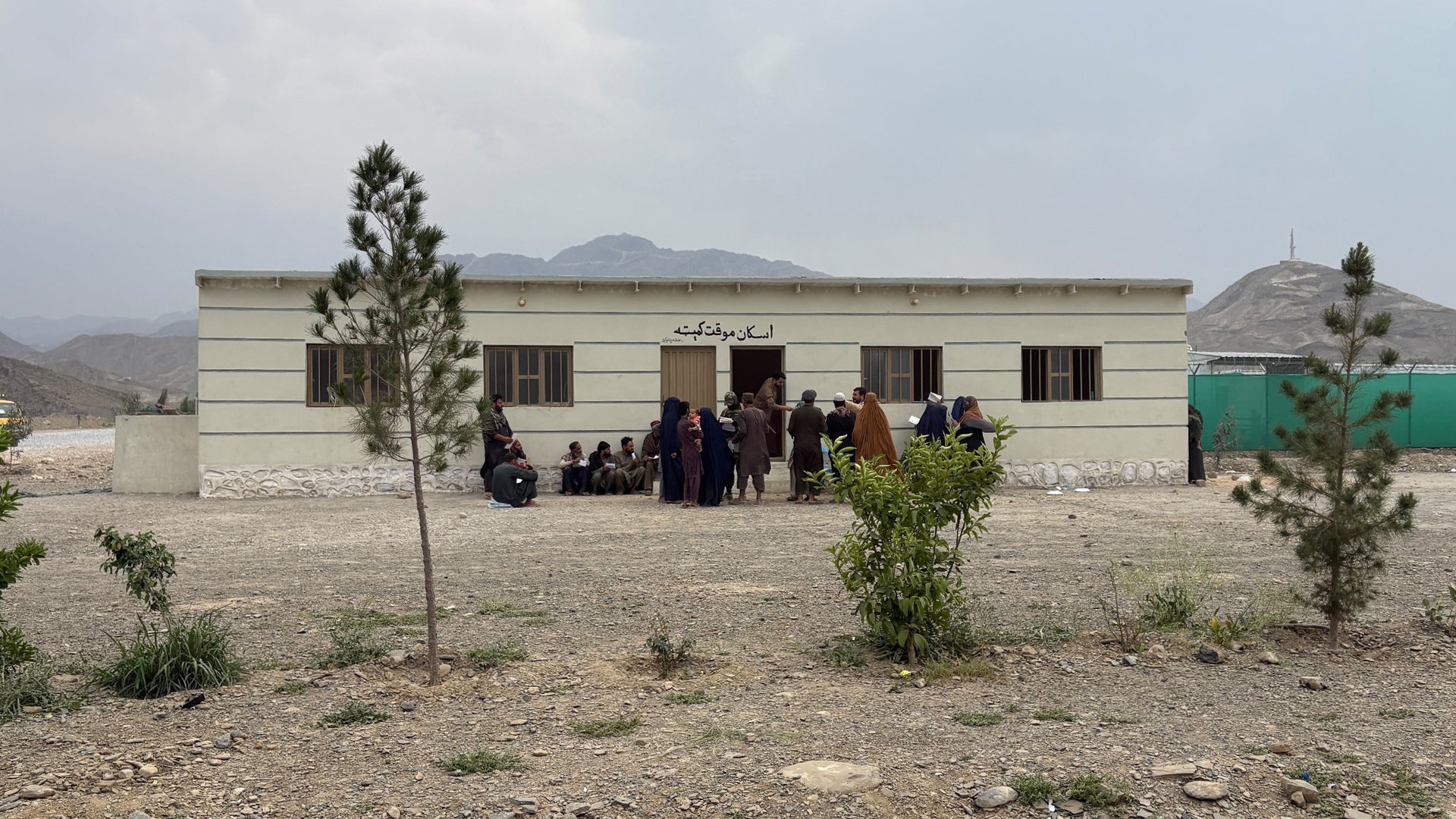 Afghan returnees stand in line hoping for assistance from the Afghan Red Crescent in Torkham district at the border between Afghanistan and Pakistan.