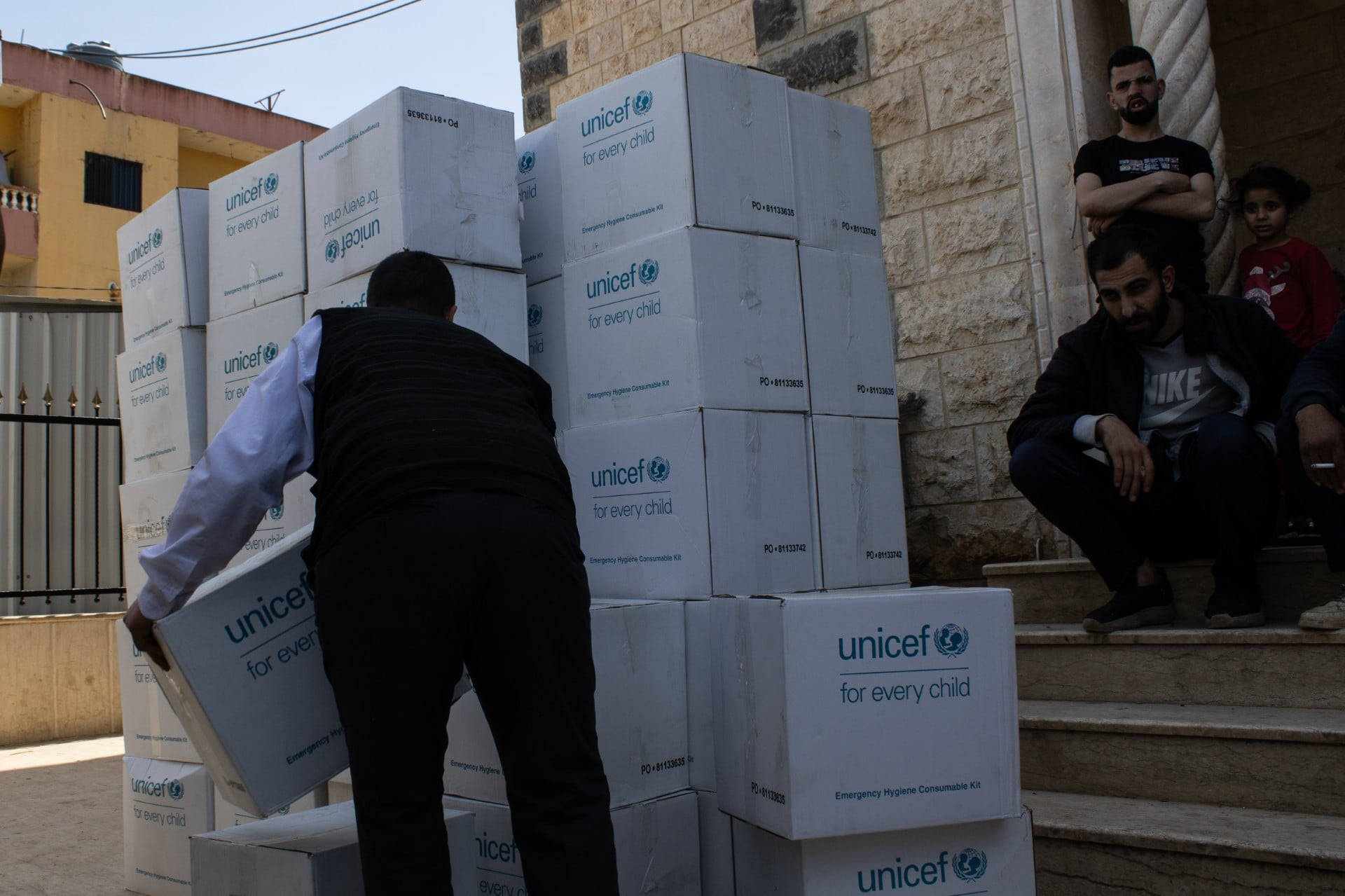 Aid boxes, filled with hygiene and cleaning products, are unloaded outside a mosque in Massoudiyeh May 15,&nbsp;Massoudiyeh, Lebanon).