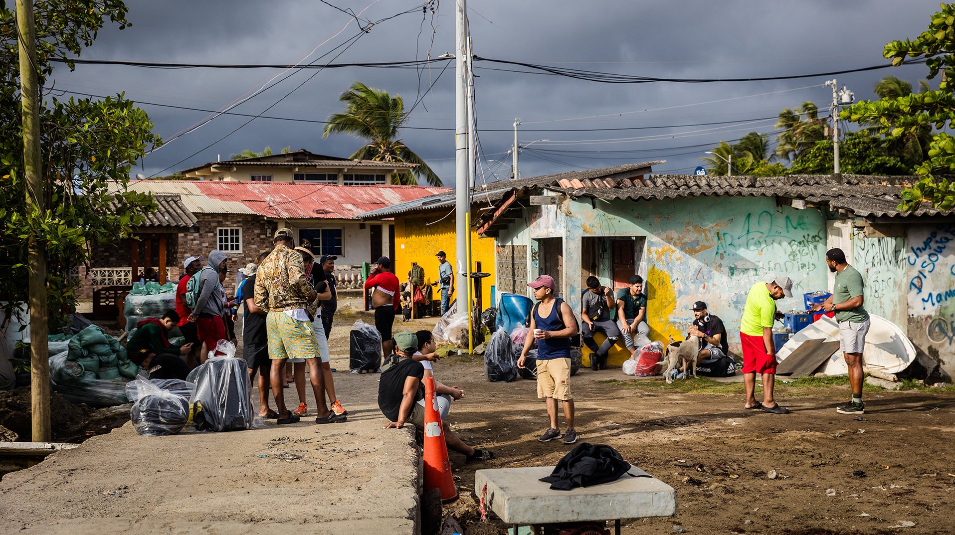 Venezuelan migrants wait near the pier in Miramar to begin the 8-hour boat ride to Puerto Obaldía, the first leg of their latest long journey, on 11 April 2025.