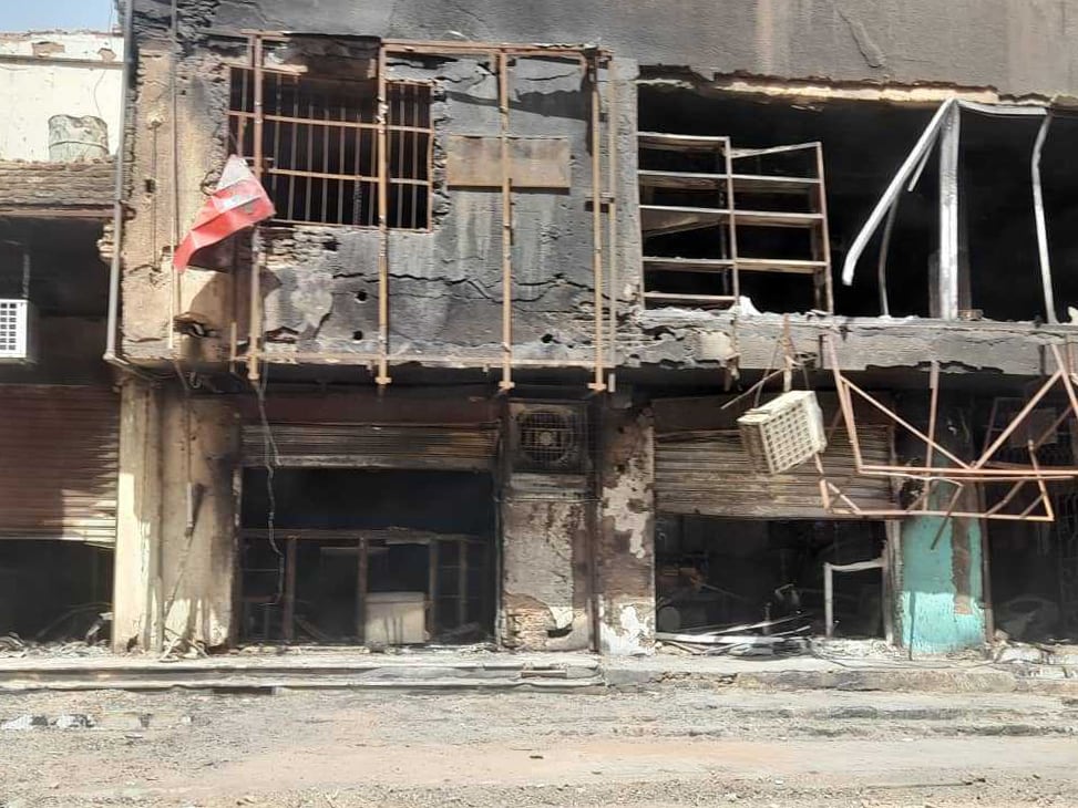 A charred and bullet-pocked tower-block bears the scars of fighting between the army and the Rapid Support Forces in Kharotum.