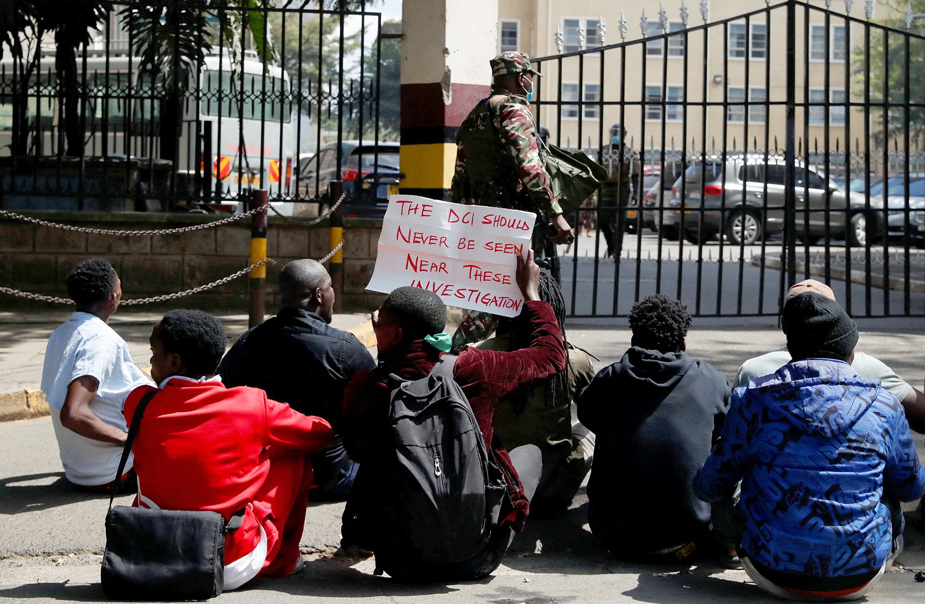 Protesters sit outside the police headquarters in Nairobi as they demonstrate on 12 June 2025 against the death of teacher Albert Ojwang' in police custody the week before.