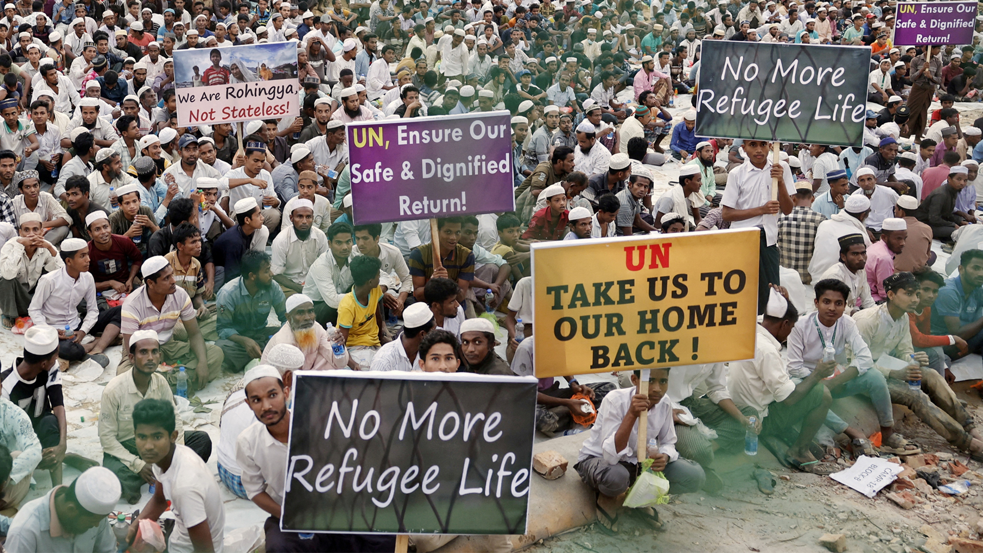 Rohingya refugees hold placards while attending a Ramadan Solidarity Iftar to have an Iftar meal with United Nations Secretary-General Antonio Guterres and Muhammad Yunus, Chief Adviser of Bangladesh Interim Government, at the Rohingya refugee camp in Cox's Bazar, Bangladesh, March 14, 2025.