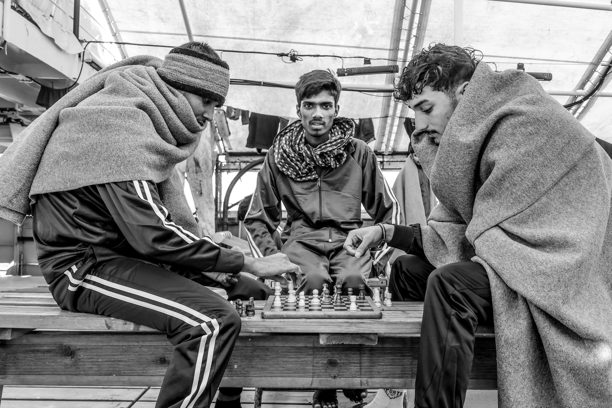 Rescued people play chess on board Humanity 1, March 2025.