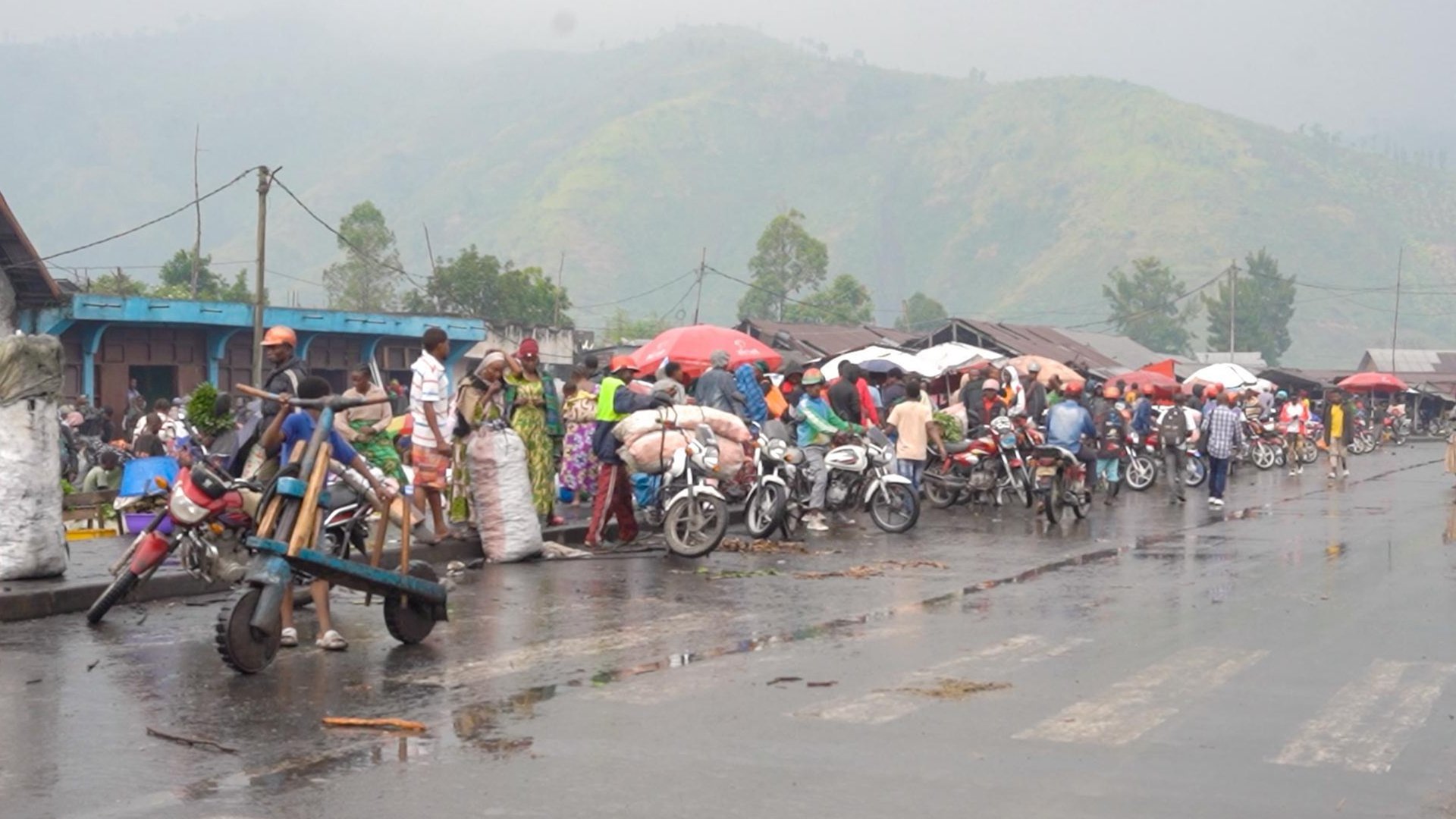 Motorbike taxi drivers by the side of the road in Sake. The town has faced intense search operations by M23 rebels to root out former soldiers and allied militia fighters. 