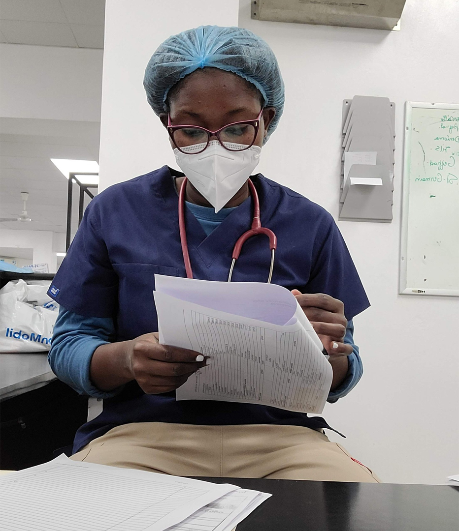Doctor Marie Alexandra Michel writes notes and reviews her patients’ lab tests at the Mirebalais University Hospital in October 2022.