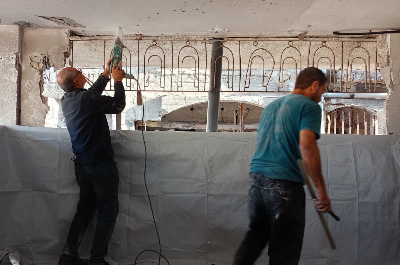 Workmen make repairs to the apartment Rasha Abou Jalal and her family have rented in Gaza City.