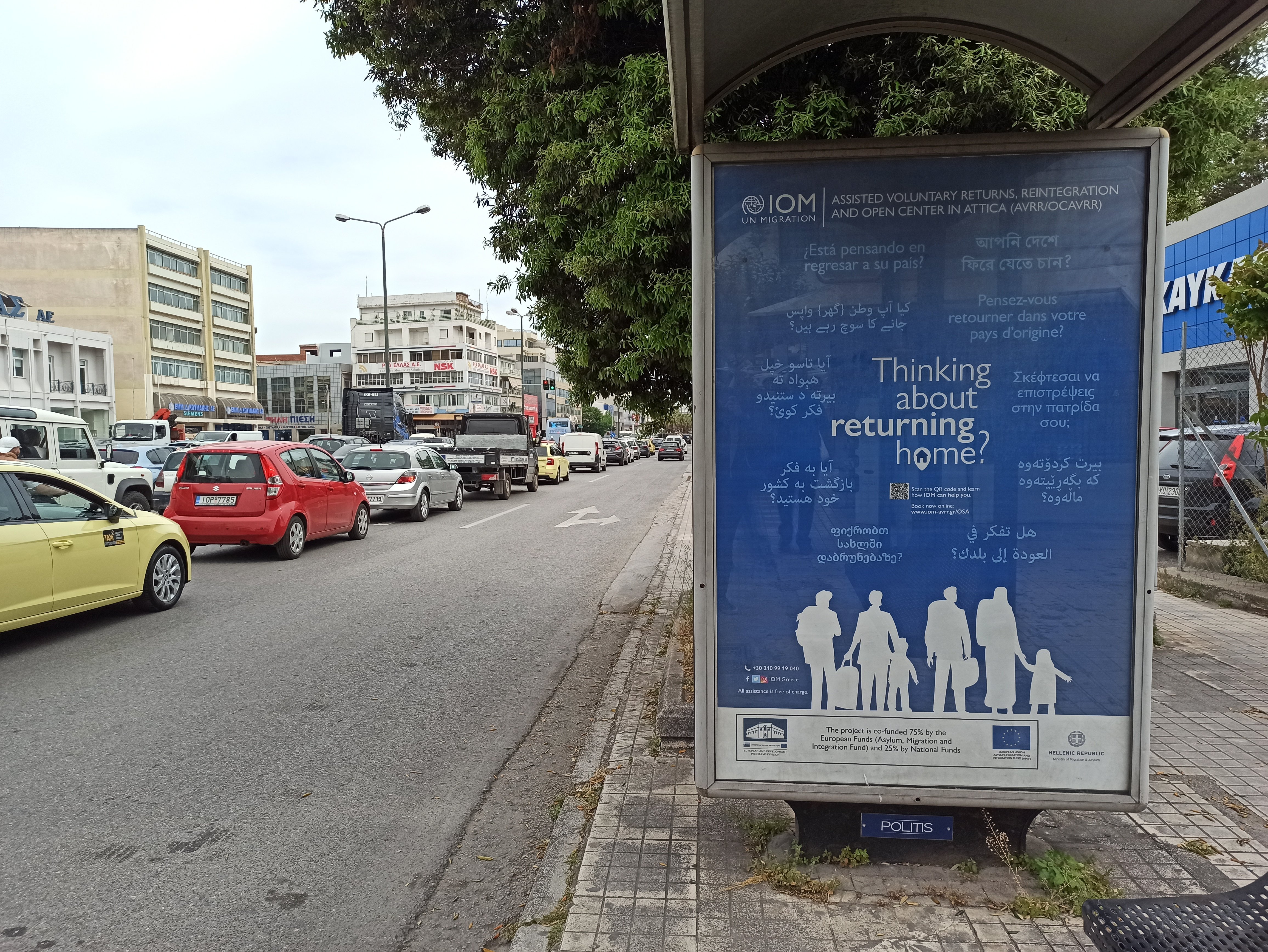 An IOM advertisement for assisted voluntary returns in Athens, Greece. Picture taken in May 2022.