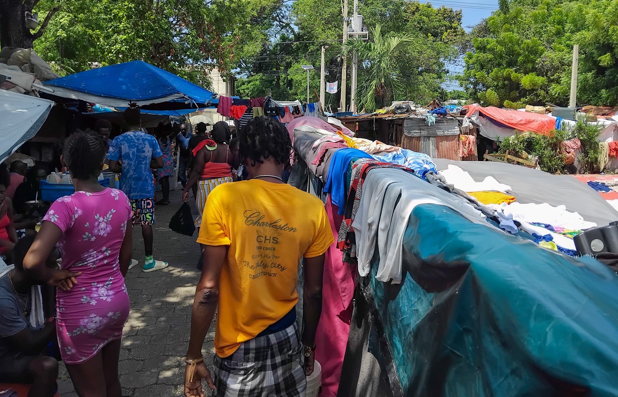 People walking through the densely populated Mormon Church displacement site, home to about 6,000 people, in Port-au-Prince.