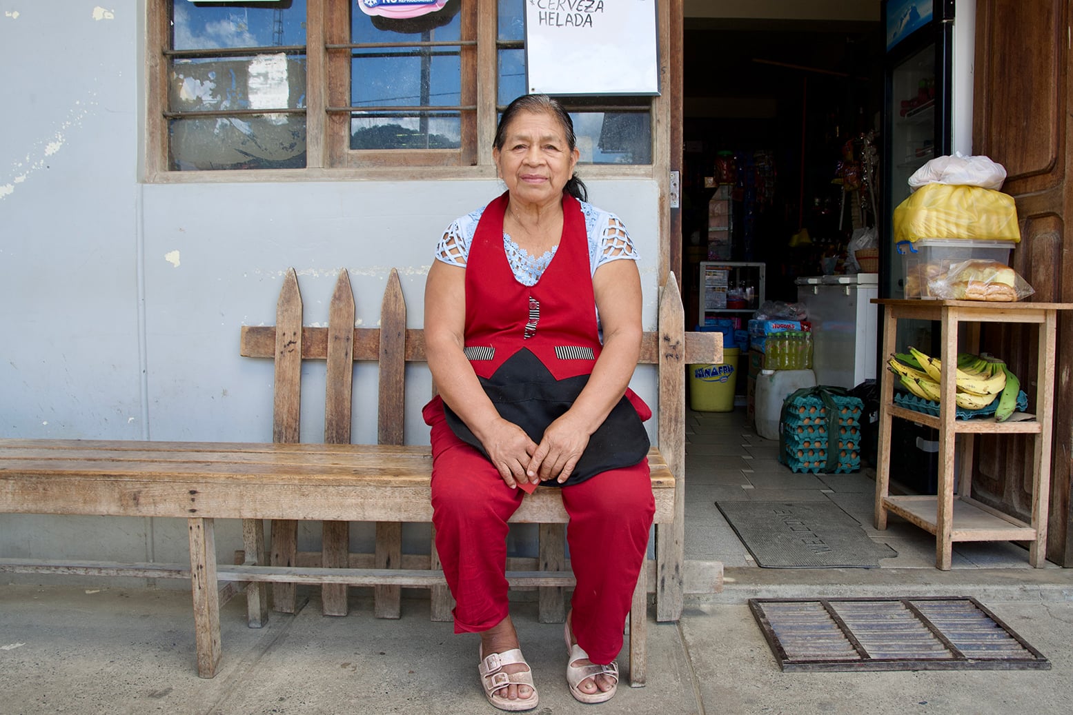 Elsa Dariquebe, sister of Victorio Dariquebe Gerewa, a park ranger killed in Madre de Dios, in southeastern Peru, in April 2024, allegedly by a hitman contracted by gold miners, in front of her shop in Pillcopata, Cusco, 13 November 2025.