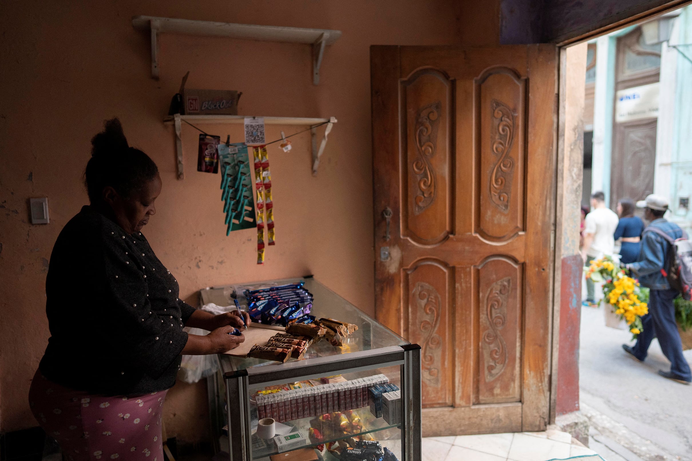 Self employed Norca Vaez, 60, works in her shop during a national electrical grid collapse, in Havana, Cuba, December 4, 2024.