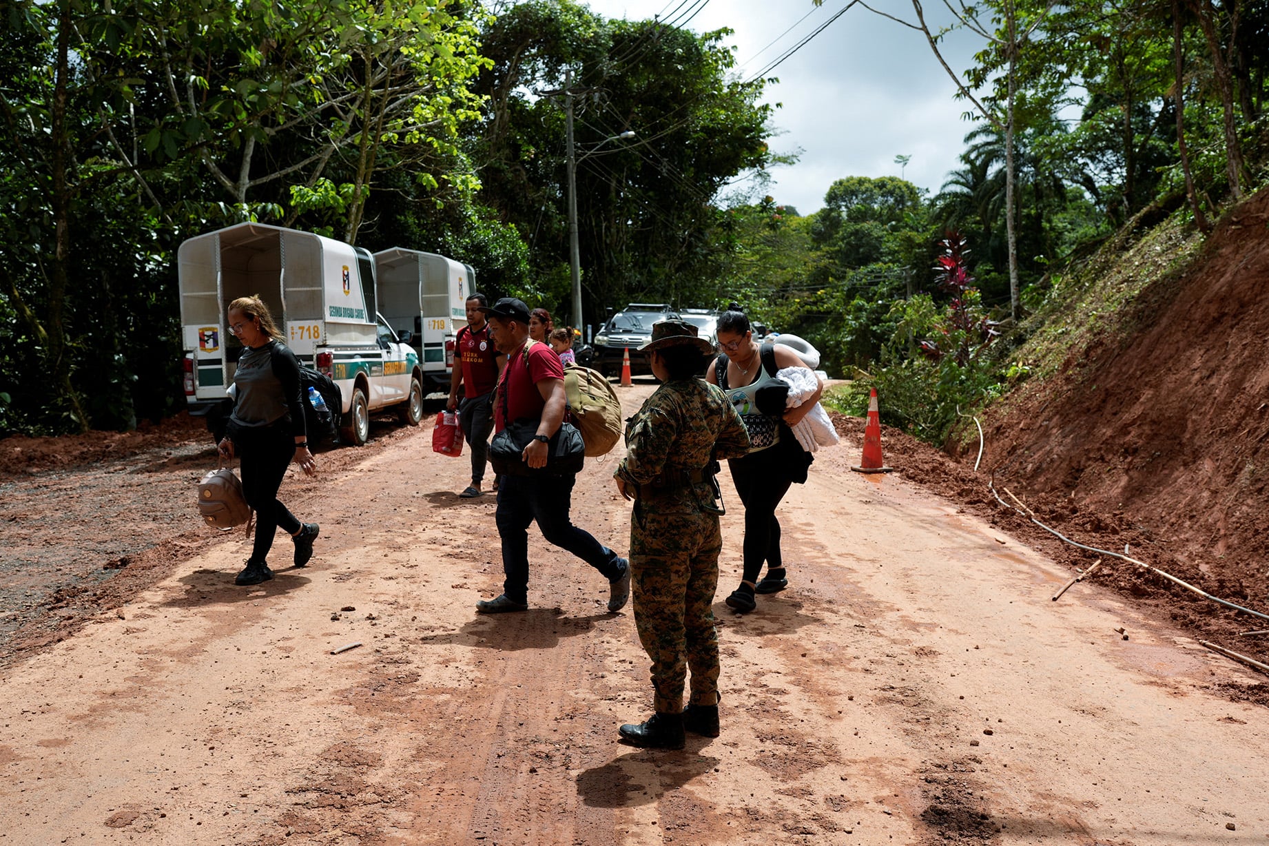 Venezuelan migrants, who were hoping to reach the U.S. and decided to return to their country due to U.S. President Donald Trump’s new immigration policies, walk near a checkpoint to get to the port and board a boat to take them to the Colombian border, in Gardi Sugdub, Panama, February 23, 2025