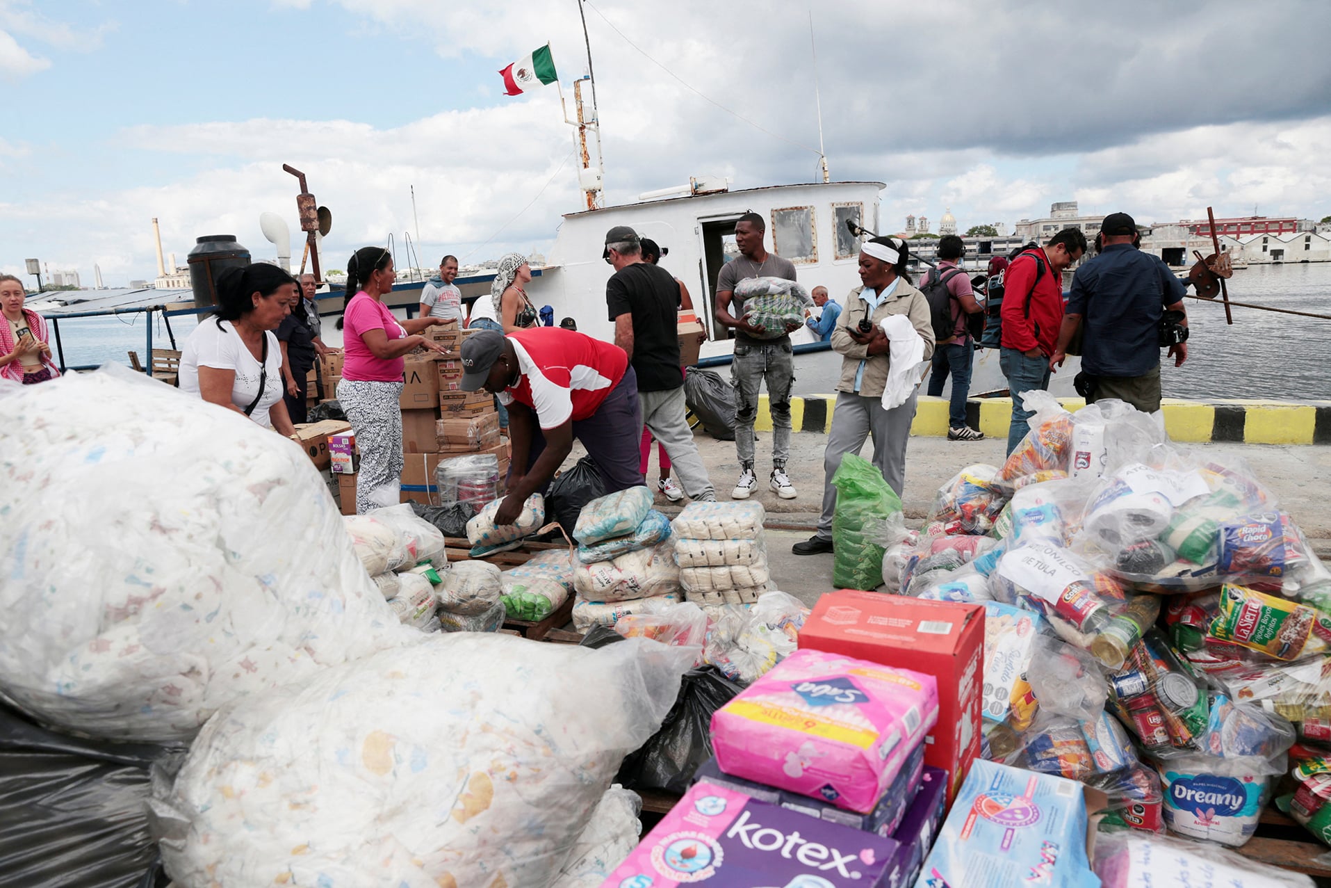 Members of a flotilla that departed from Mexico, together with local port workers, unload humanitarian aid upon their arrival to Havana's bay amid a U.S. oil blockade that has dealt a major blow to the island's already ailing energy infrastructure, in Havana, Cuba, March 24, 2026. 