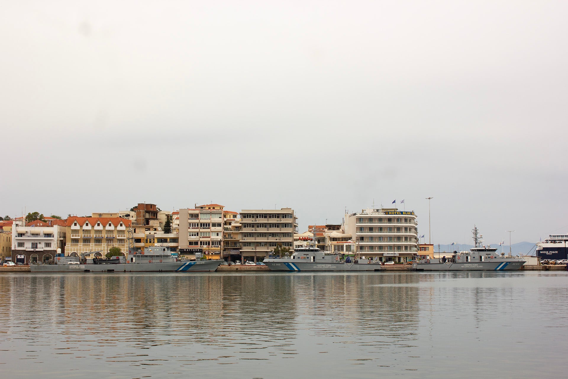 Coast Guard ships on the water on the seafront of the town.