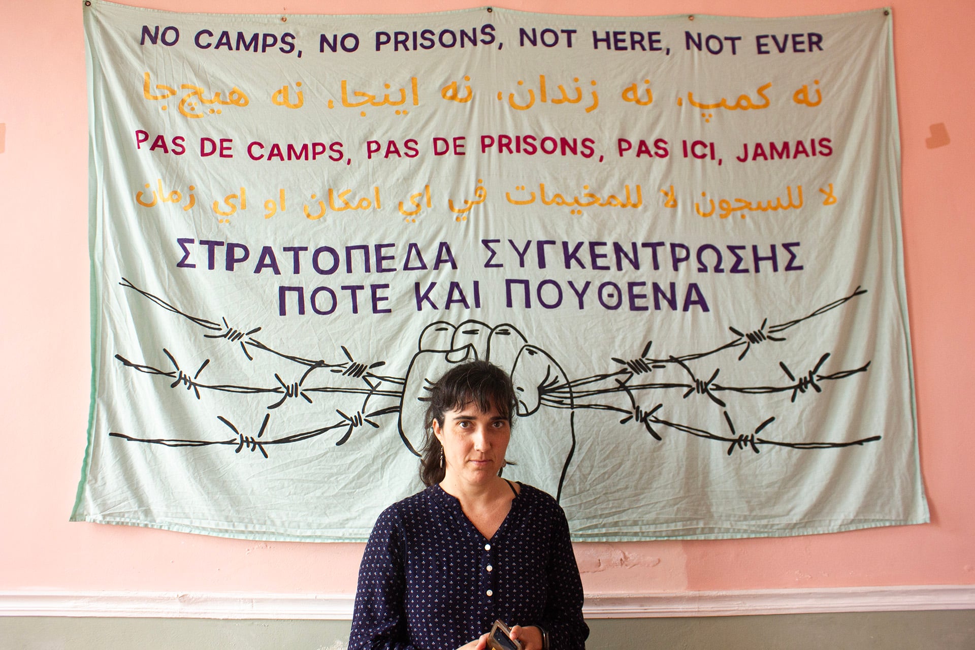 Portrait of a person in front of a banner inside