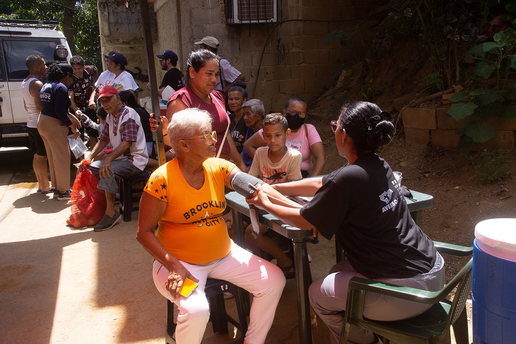 Residents of a remote community in Caraballeda, La Guaira state, receive medical care from Venezuelan NGO Avessoc, on 9 July 2026.