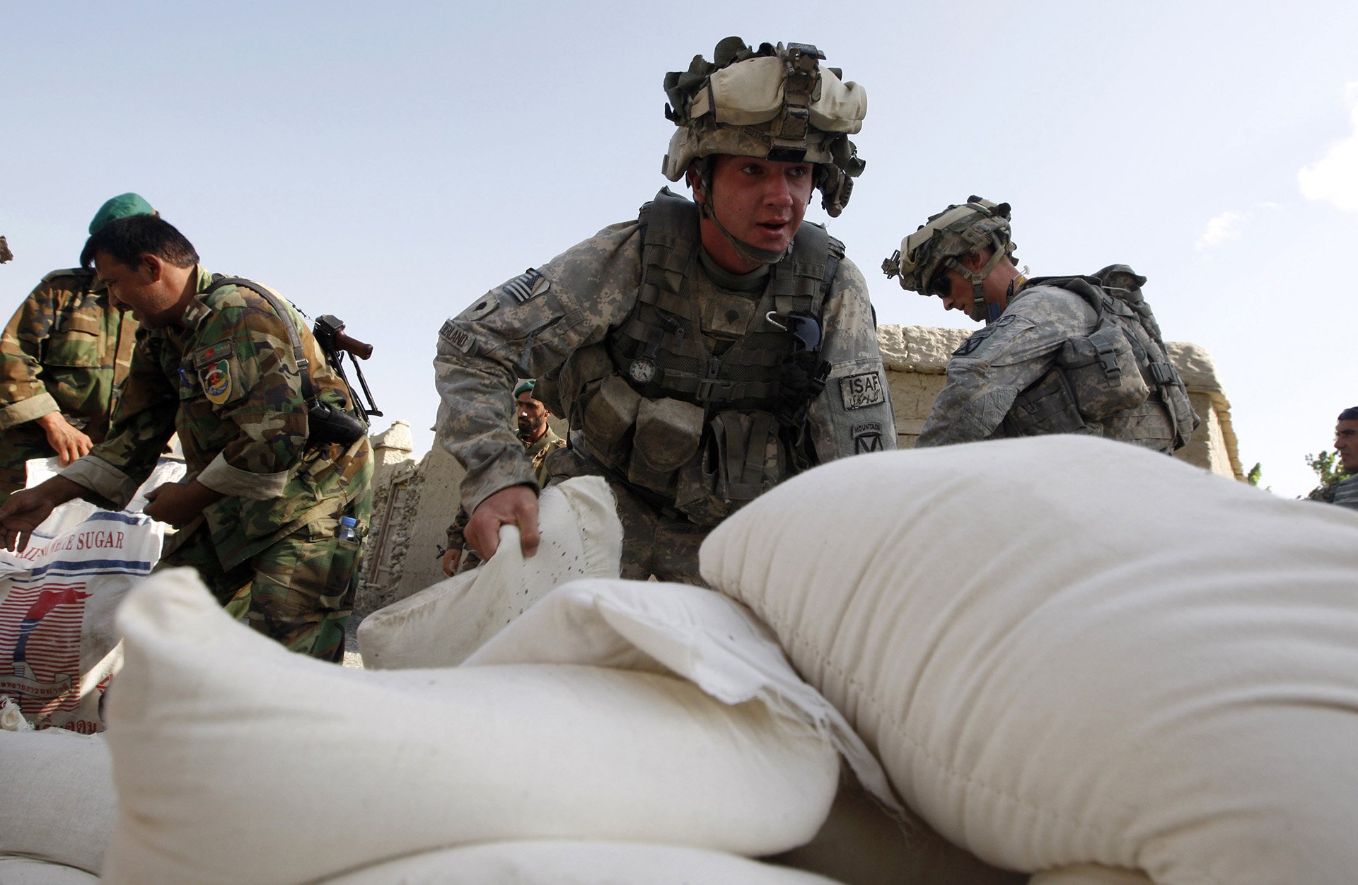 U.S. soldiers unload bags of humanitarian aid in Afghanistan